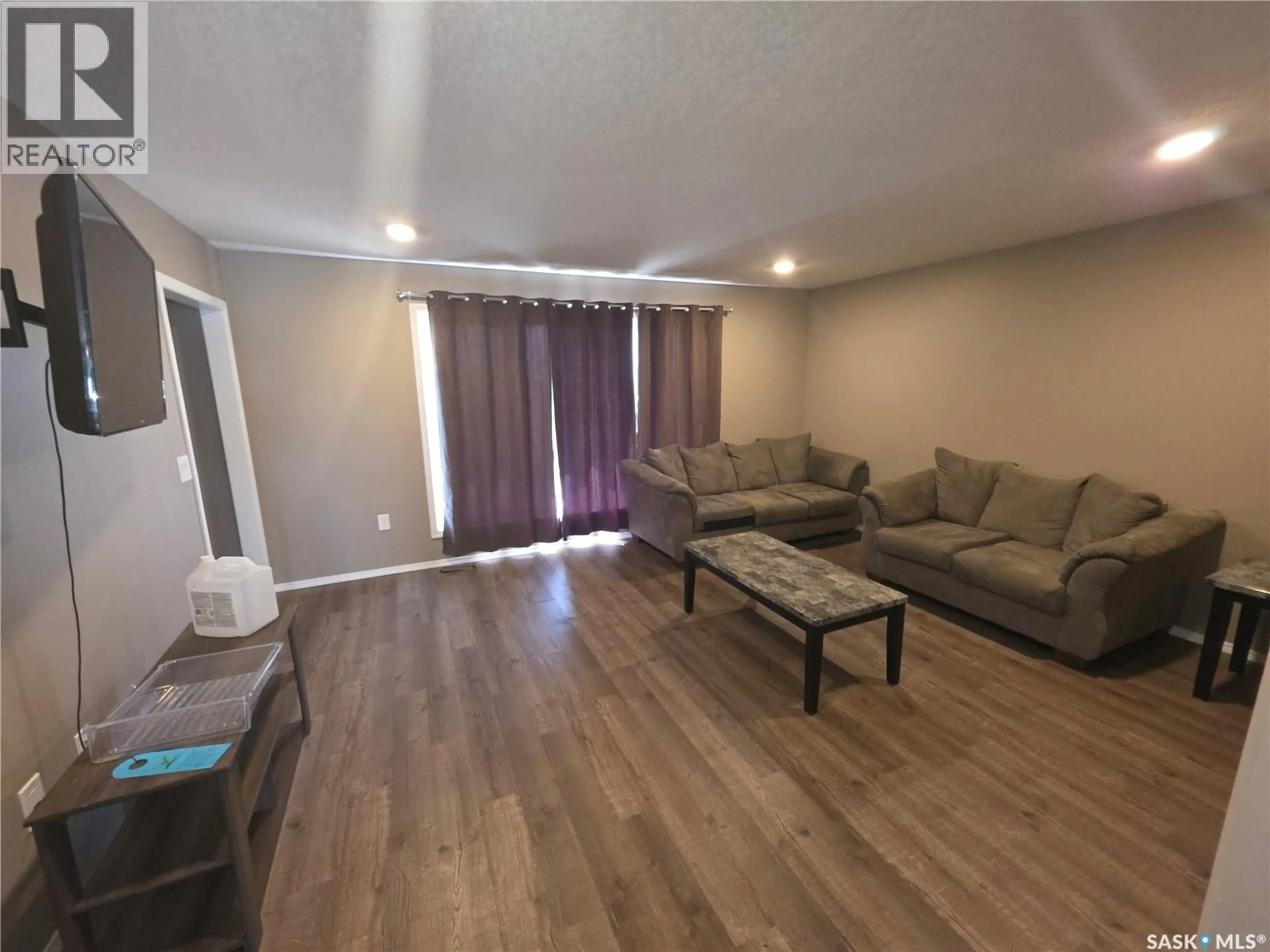 Living room with furniture, wood/laminate floor for 716 COLUMBIA AVENUE, Kerrobert Saskatchewan S0L1R0