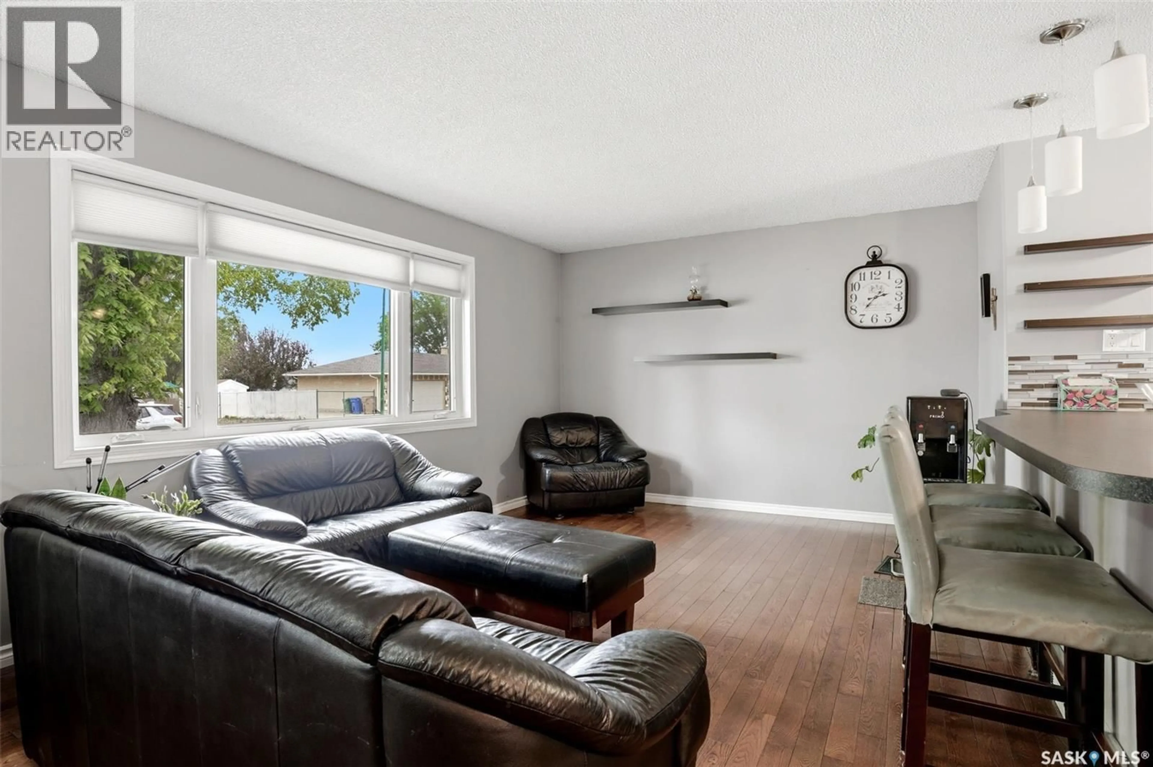 Living room with furniture, wood/laminate floor for 14 WHEELER CRESCENT, Regina Saskatchewan S4R6H5