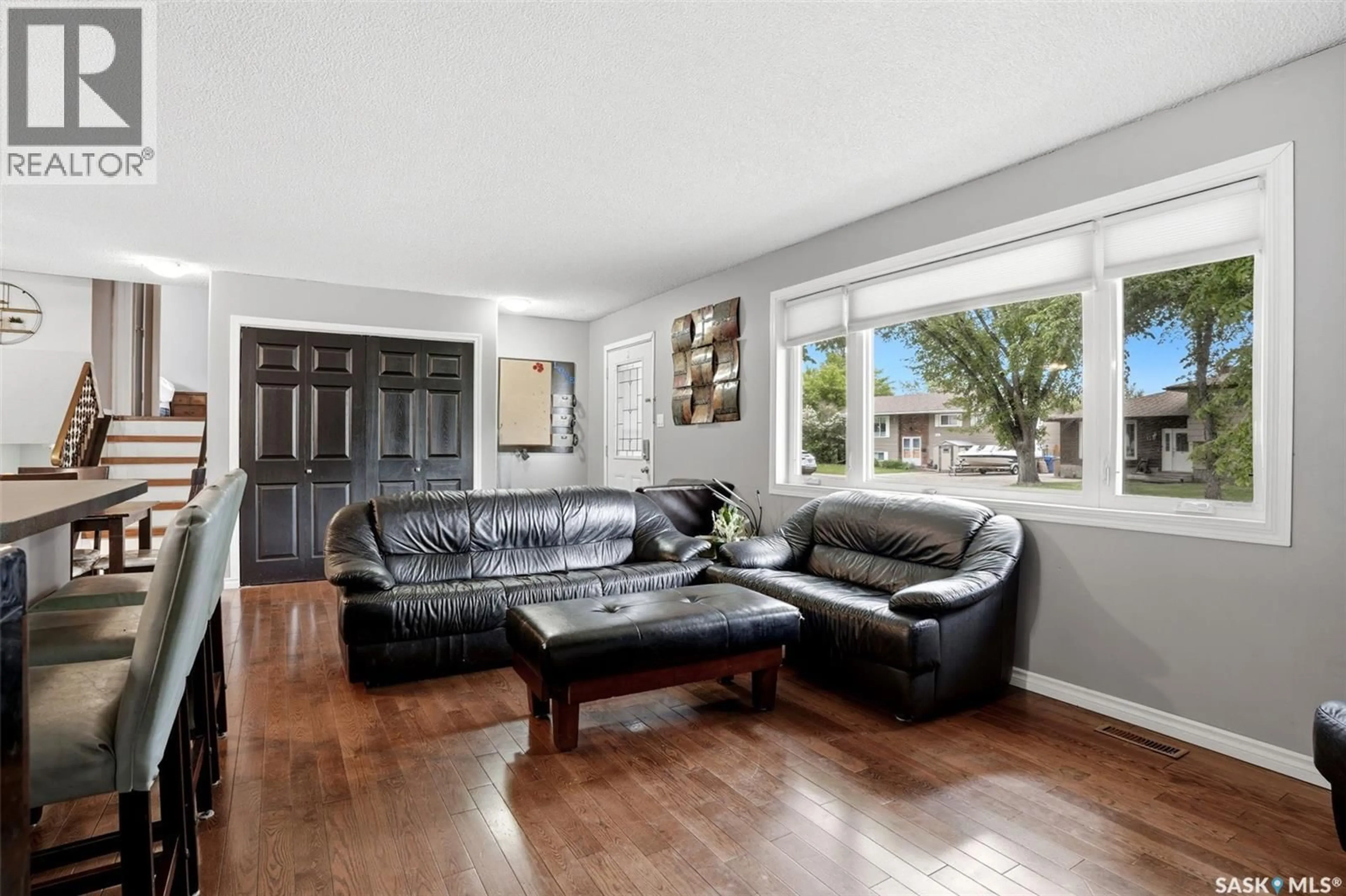 Living room with furniture, wood/laminate floor for 14 WHEELER CRESCENT, Regina Saskatchewan S4R6H5
