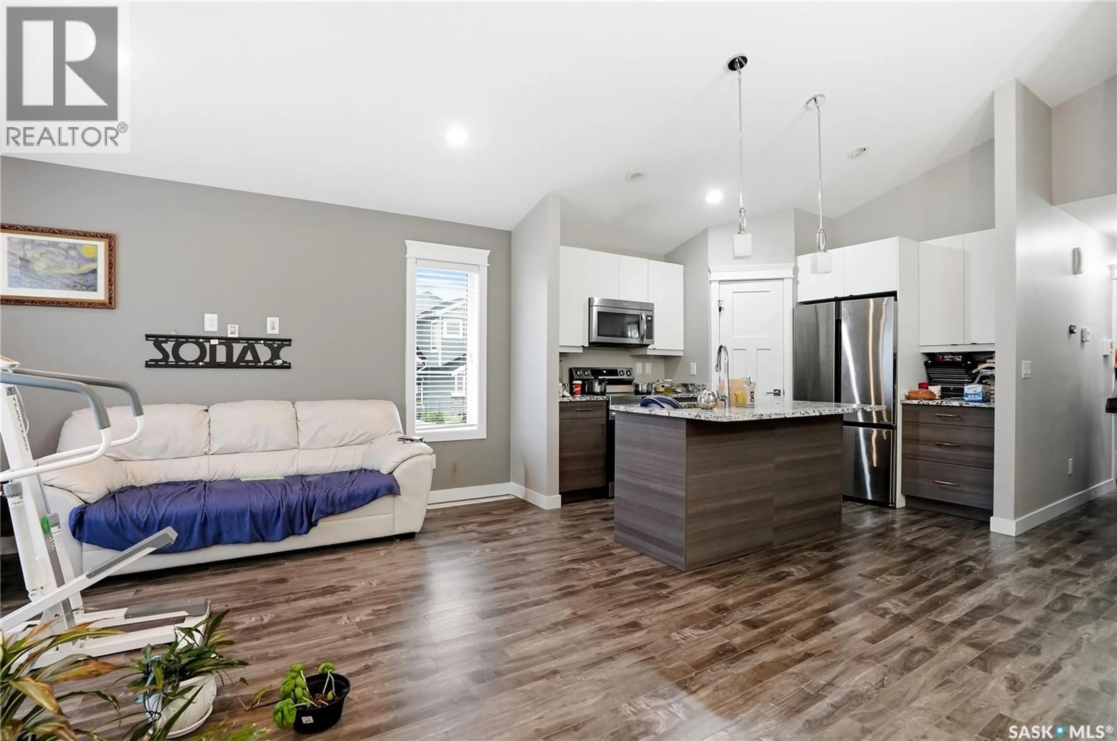 Open concept kitchen, wood/laminate floor for 503 FAST WAY, Saskatoon Saskatchewan S7P0B6