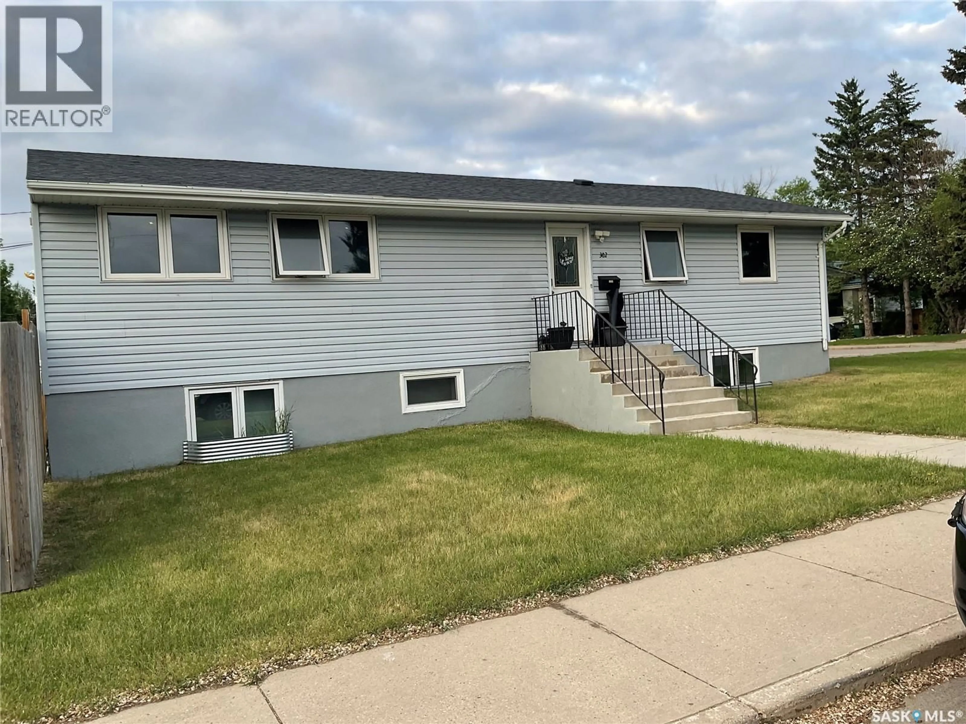 Home with vinyl exterior material, street for 302 DUNLOP STREET, Saskatoon Saskatchewan S7N2P7