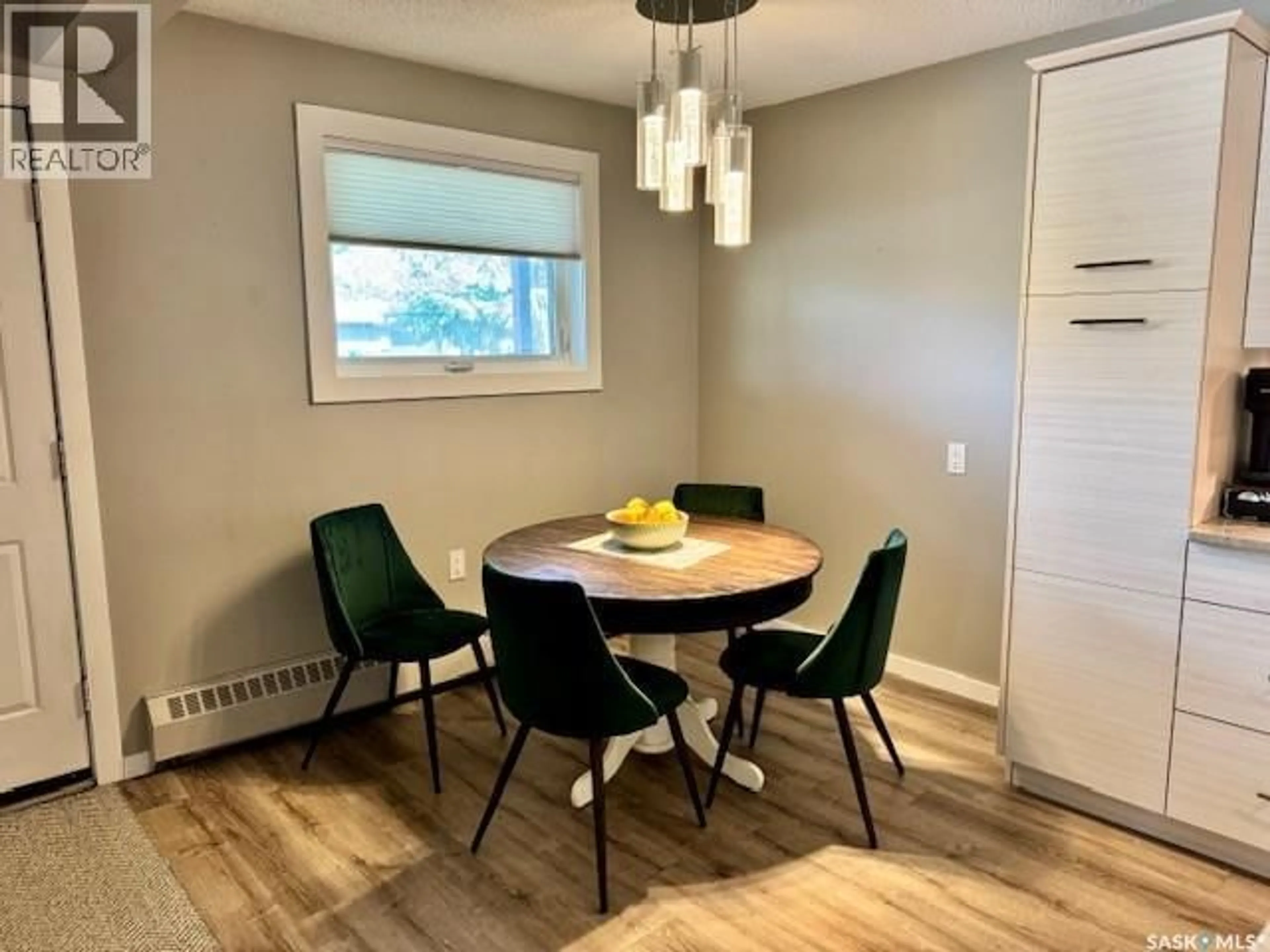 Dining room, wood/laminate floor for 105 - 2921 HARDING STREET, Regina Saskatchewan S4V1B9
