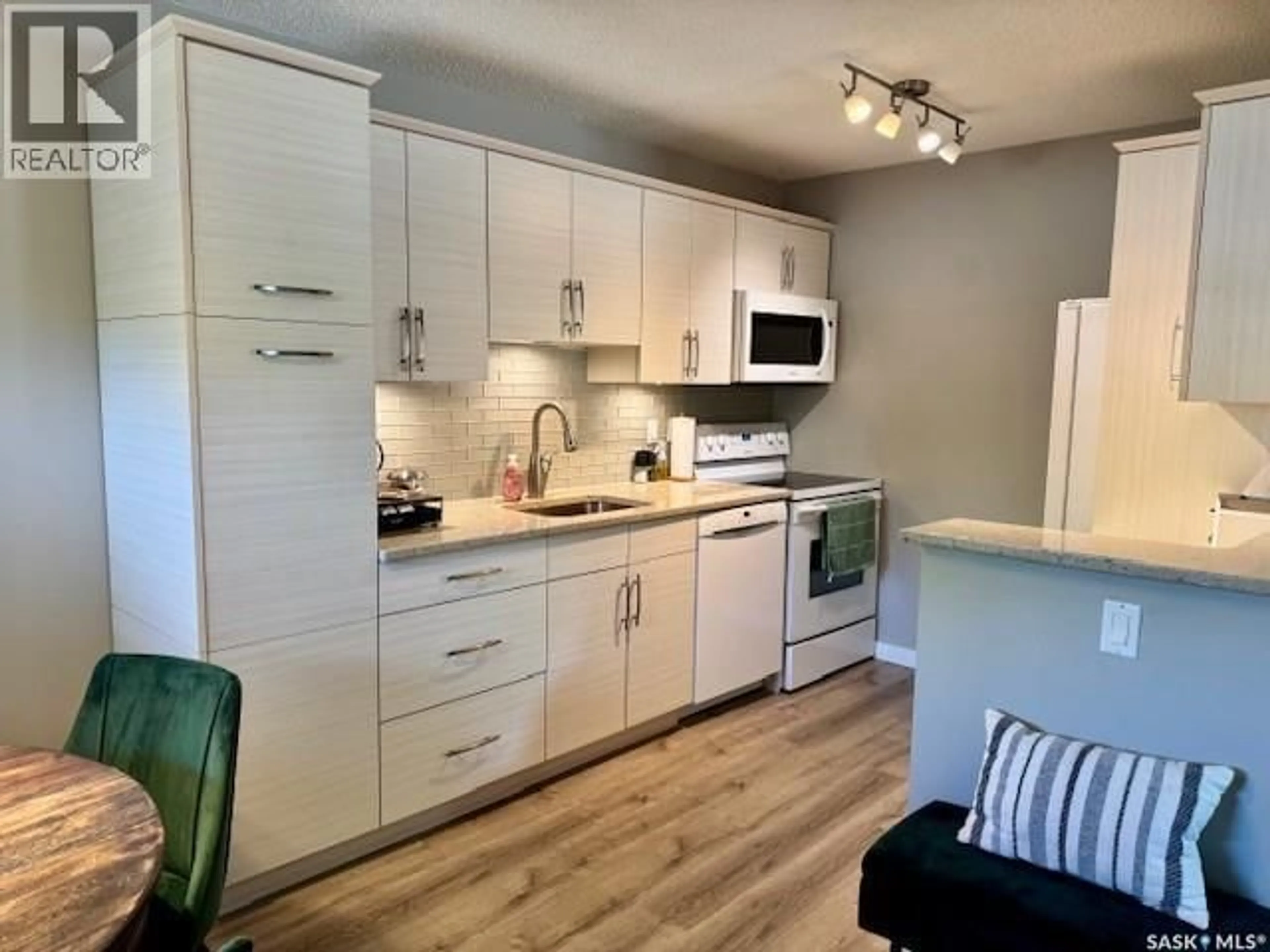Open concept kitchen, wood/laminate floor for 105 - 2921 HARDING STREET, Regina Saskatchewan S4V1B9