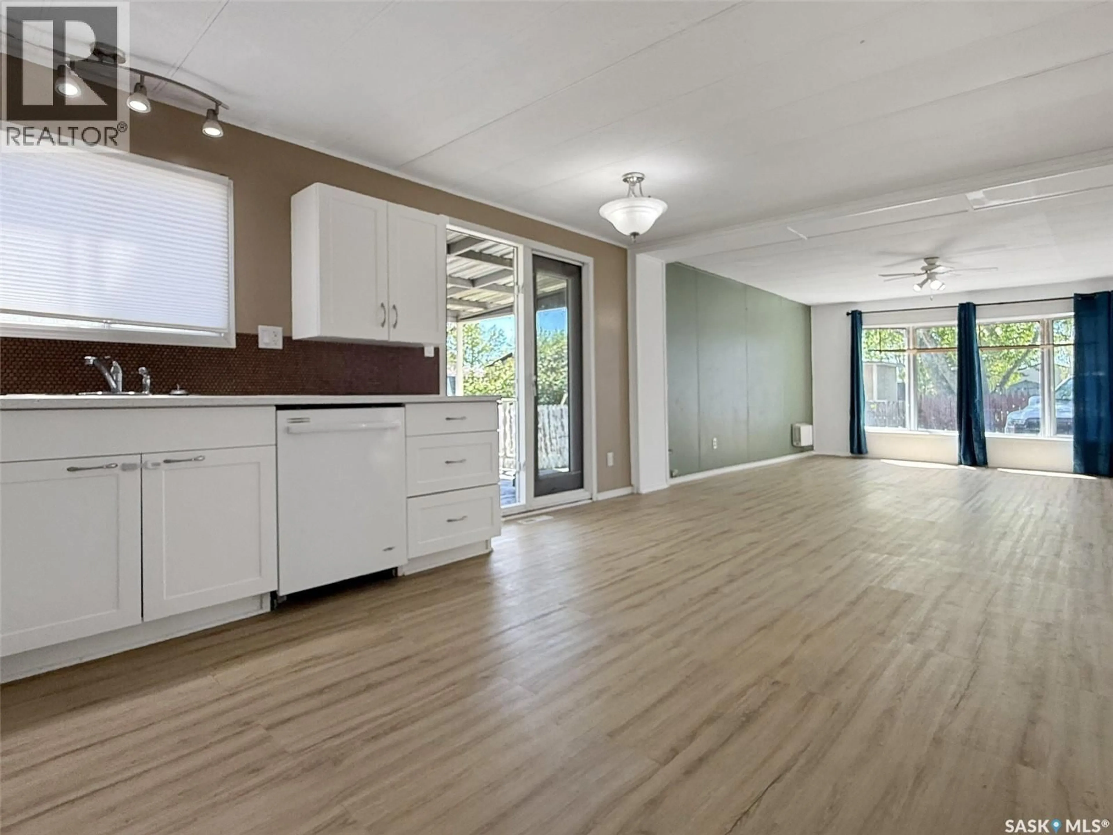 Open concept kitchen, wood/laminate floor for 10 PRAIRIE SUN COURT, Swift Current Saskatchewan S9H3X6