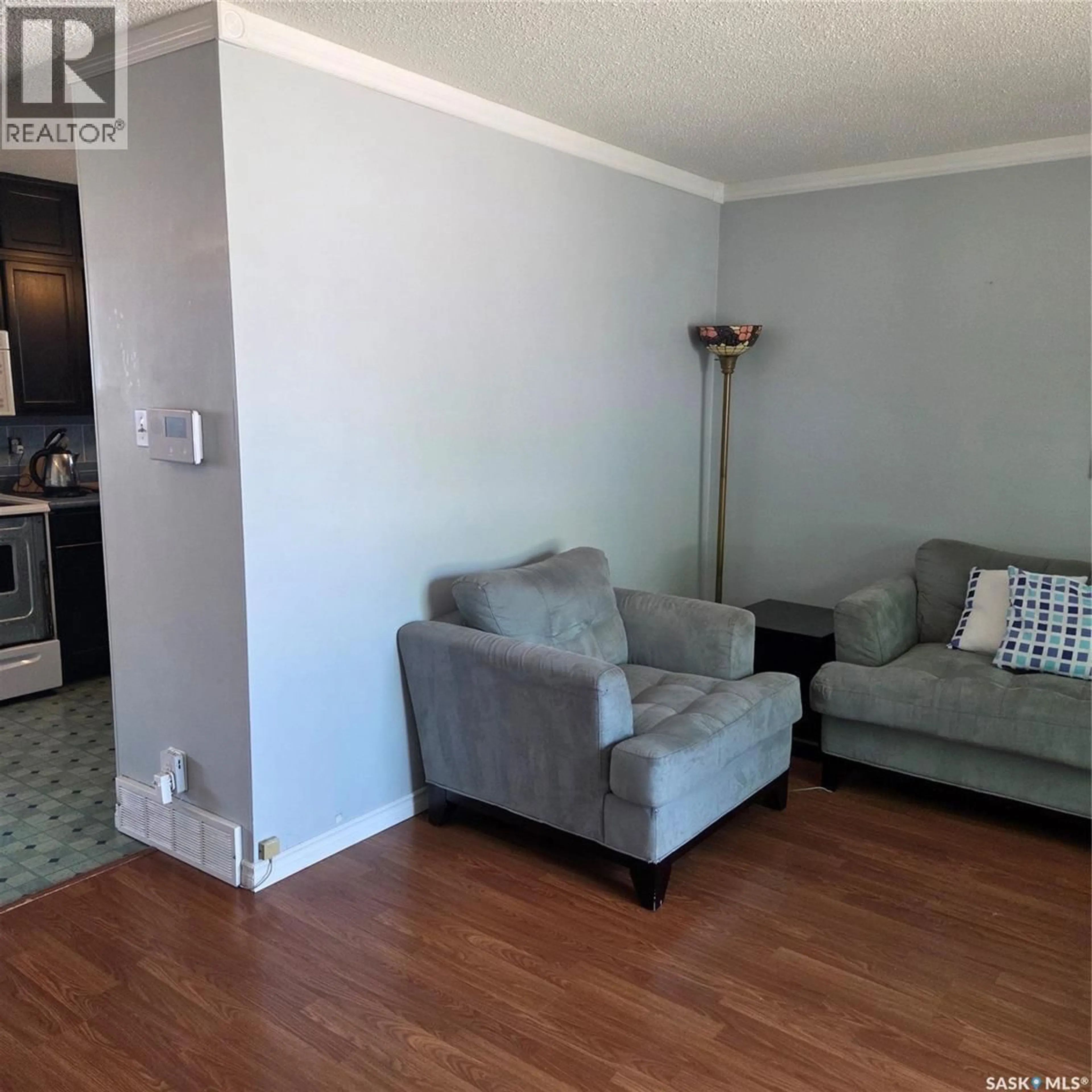 Living room with furniture, wood/laminate floor for 1107 LILLOOET STREET, Moose Jaw Saskatchewan S6H5A2