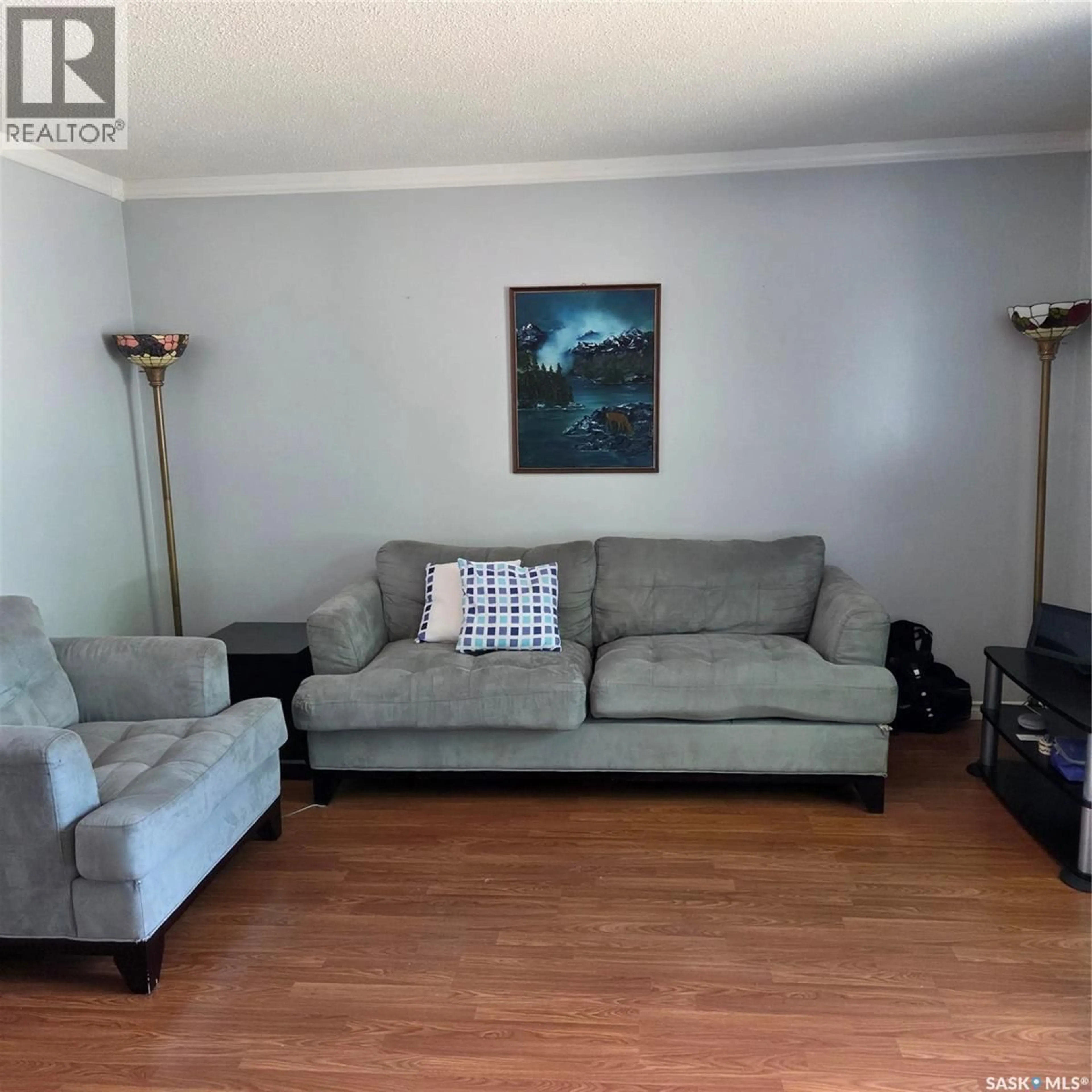 Living room with furniture, wood/laminate floor for 1107 LILLOOET STREET, Moose Jaw Saskatchewan S6H5A2