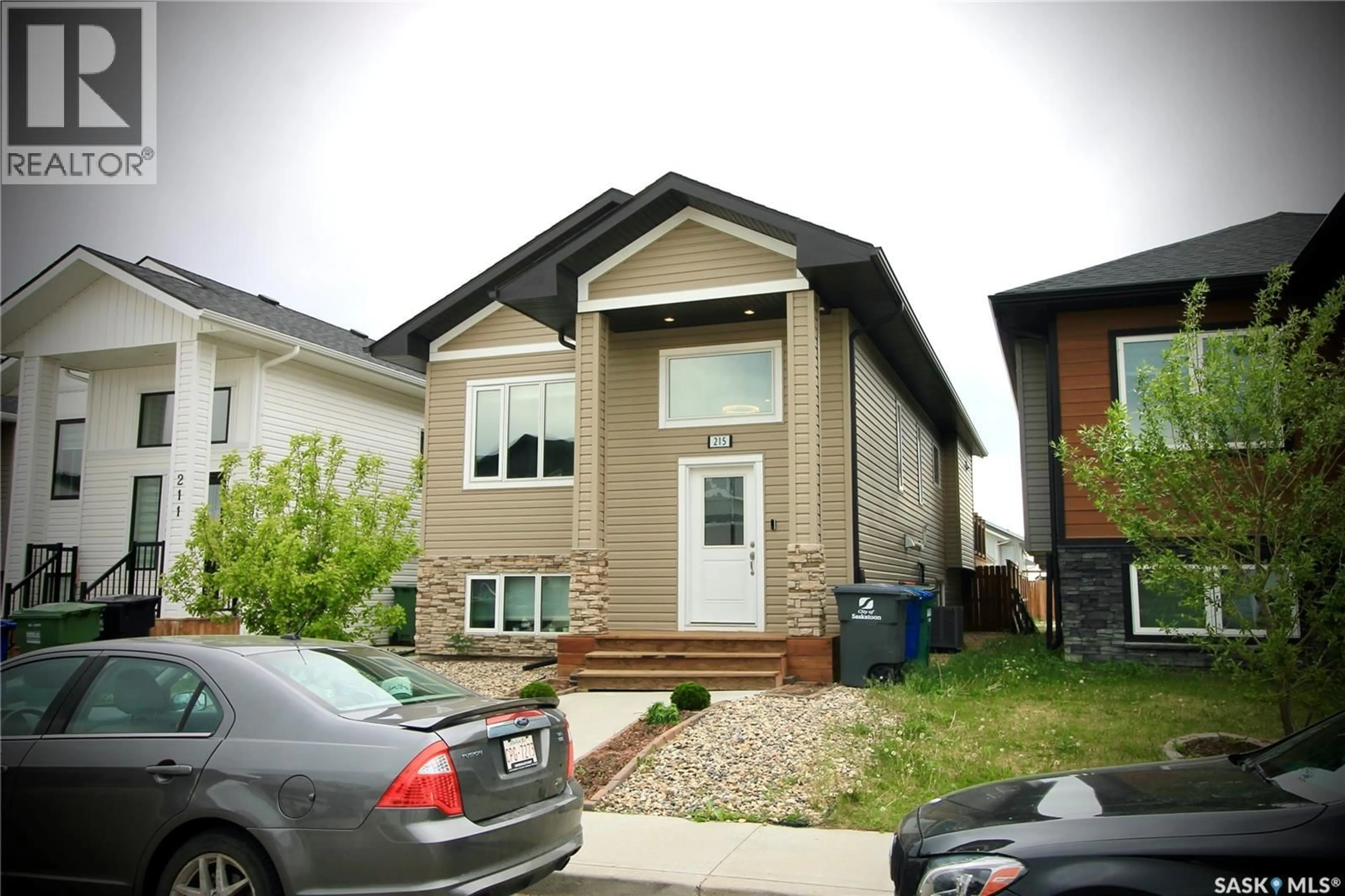 Home with vinyl exterior material, street for 215 THAKUR STREET, Saskatoon Saskatchewan S7W1C4