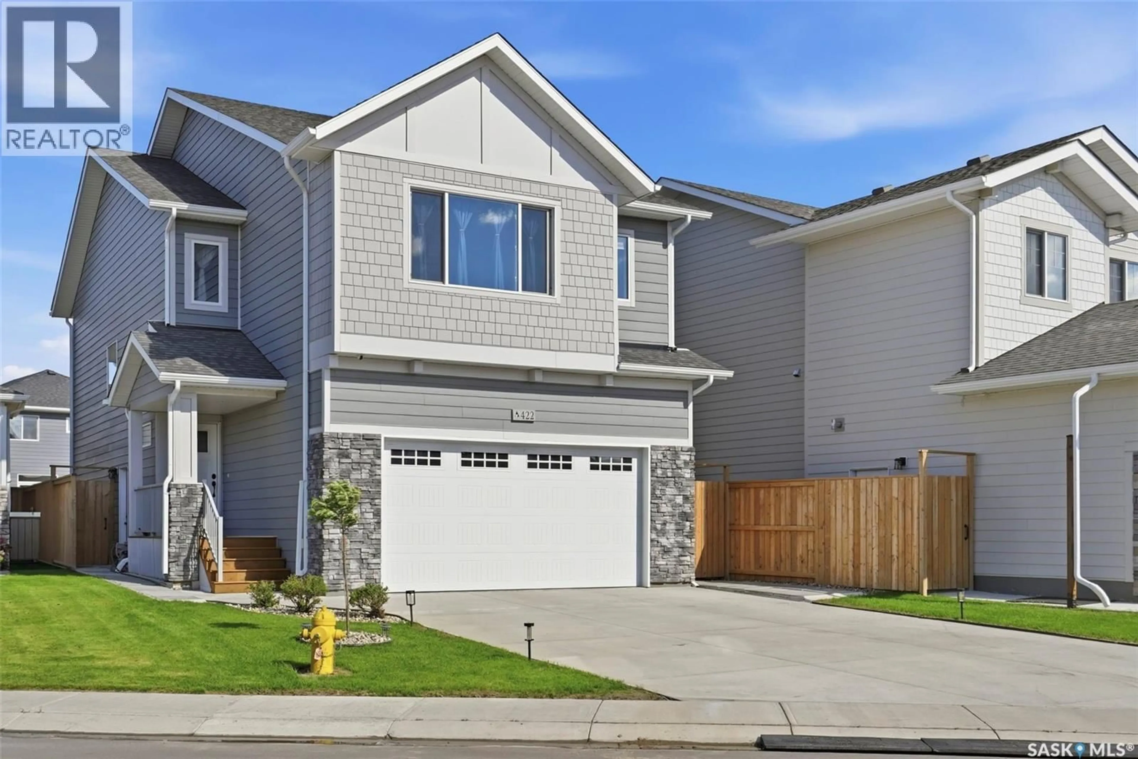 Home with vinyl exterior material, street for 422 KEITH TURN, Saskatoon Saskatchewan S7V0X8