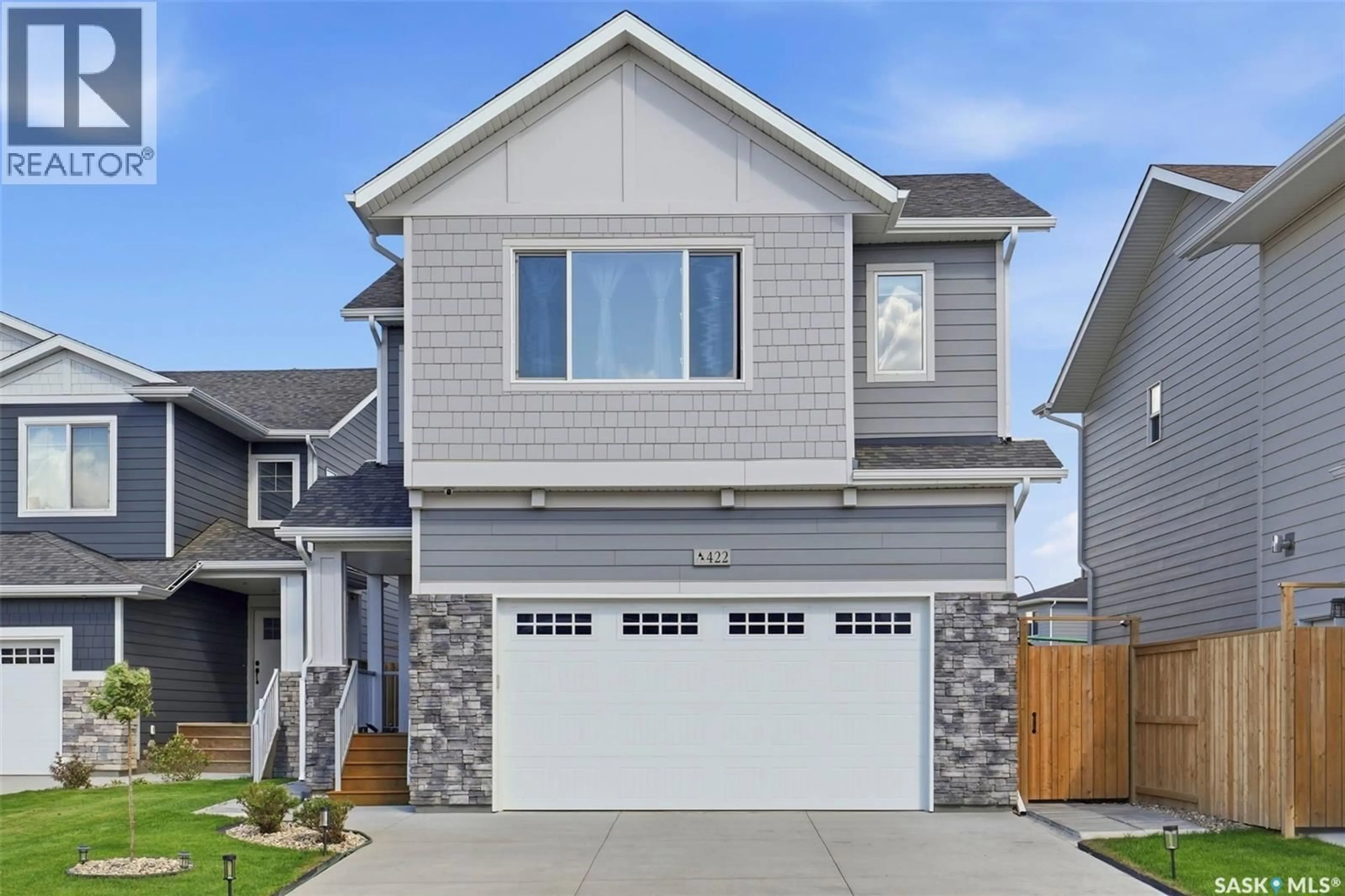 Home with vinyl exterior material, street for 422 KEITH TURN, Saskatoon Saskatchewan S7V0X8