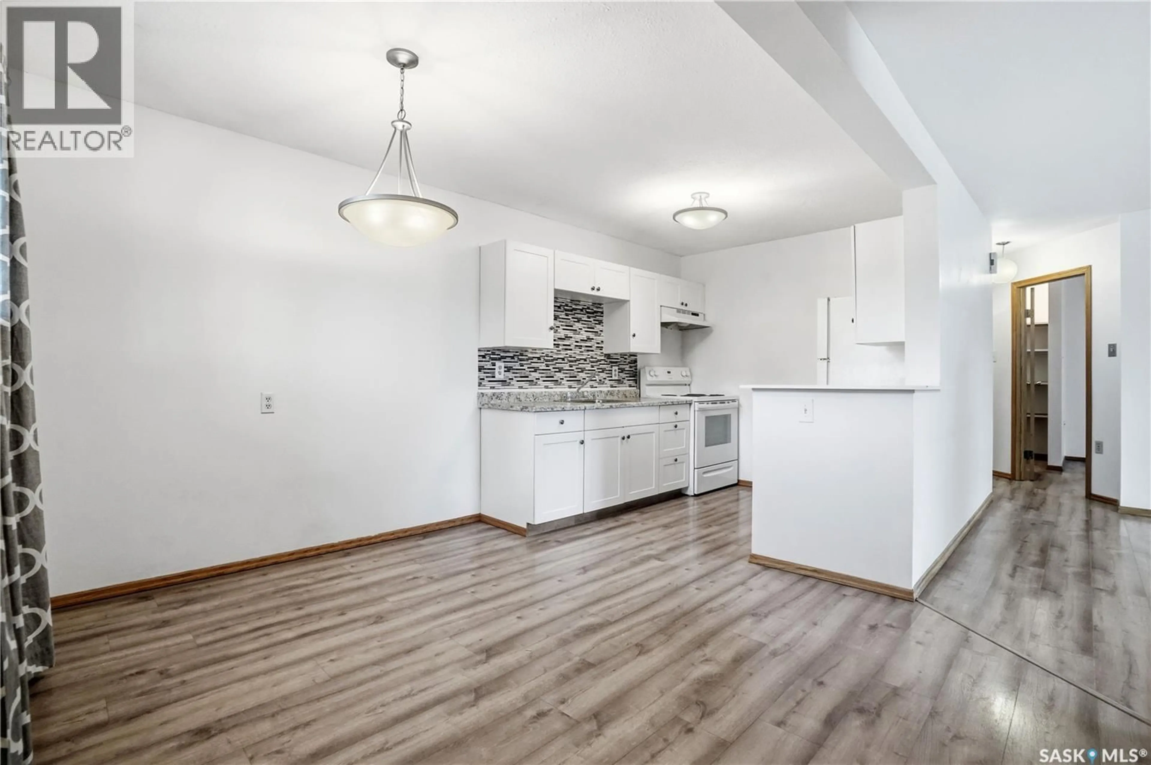 Open concept kitchen, wood/laminate floor for 105 - 2511 NEFF ROAD, Regina Saskatchewan S4V1C1
