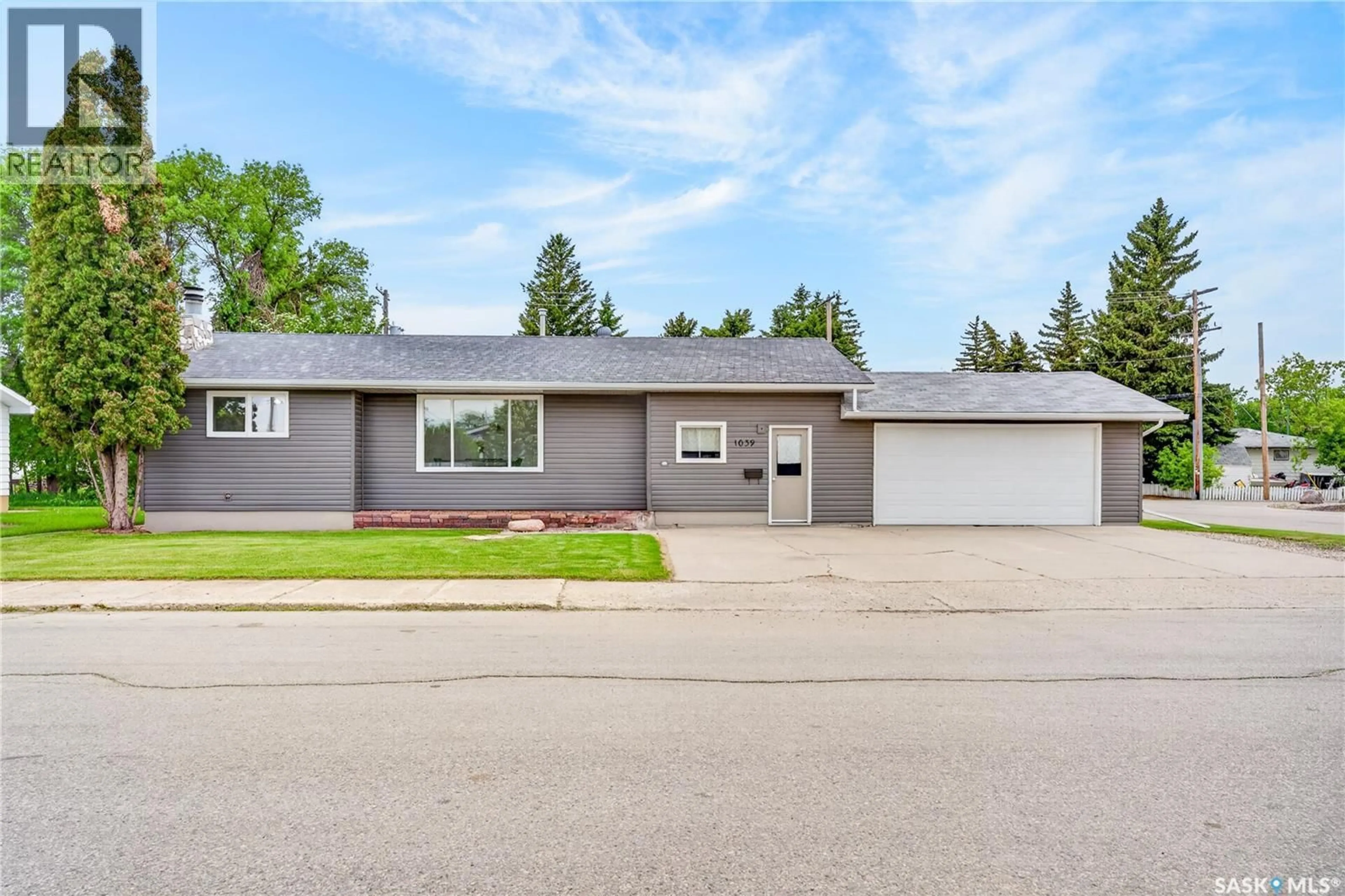Home with vinyl exterior material, street for 1039 7TH STREET, Humboldt Saskatchewan S0K2A0