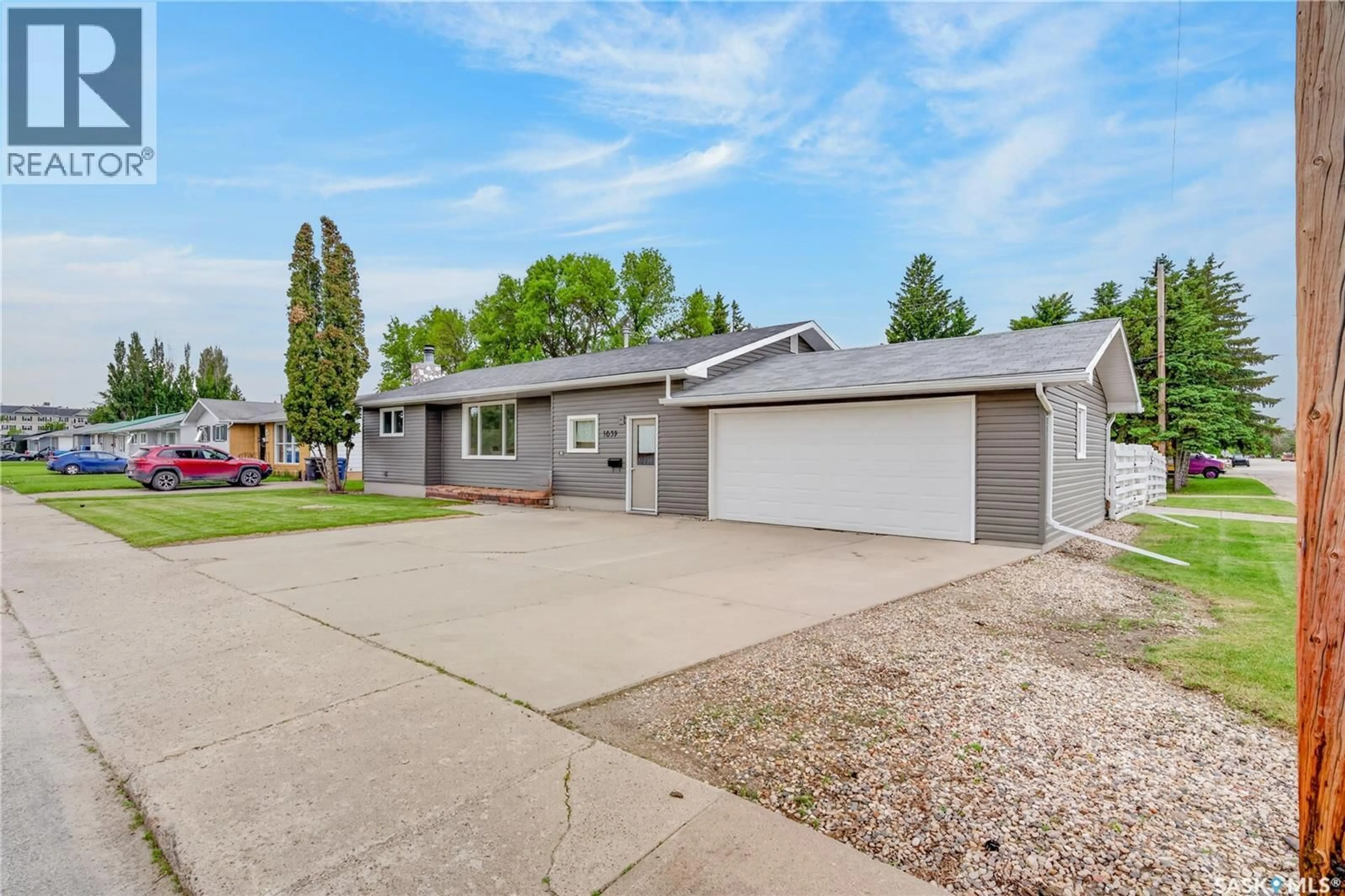 Home with vinyl exterior material, street for 1039 7TH STREET, Humboldt Saskatchewan S0K2A0