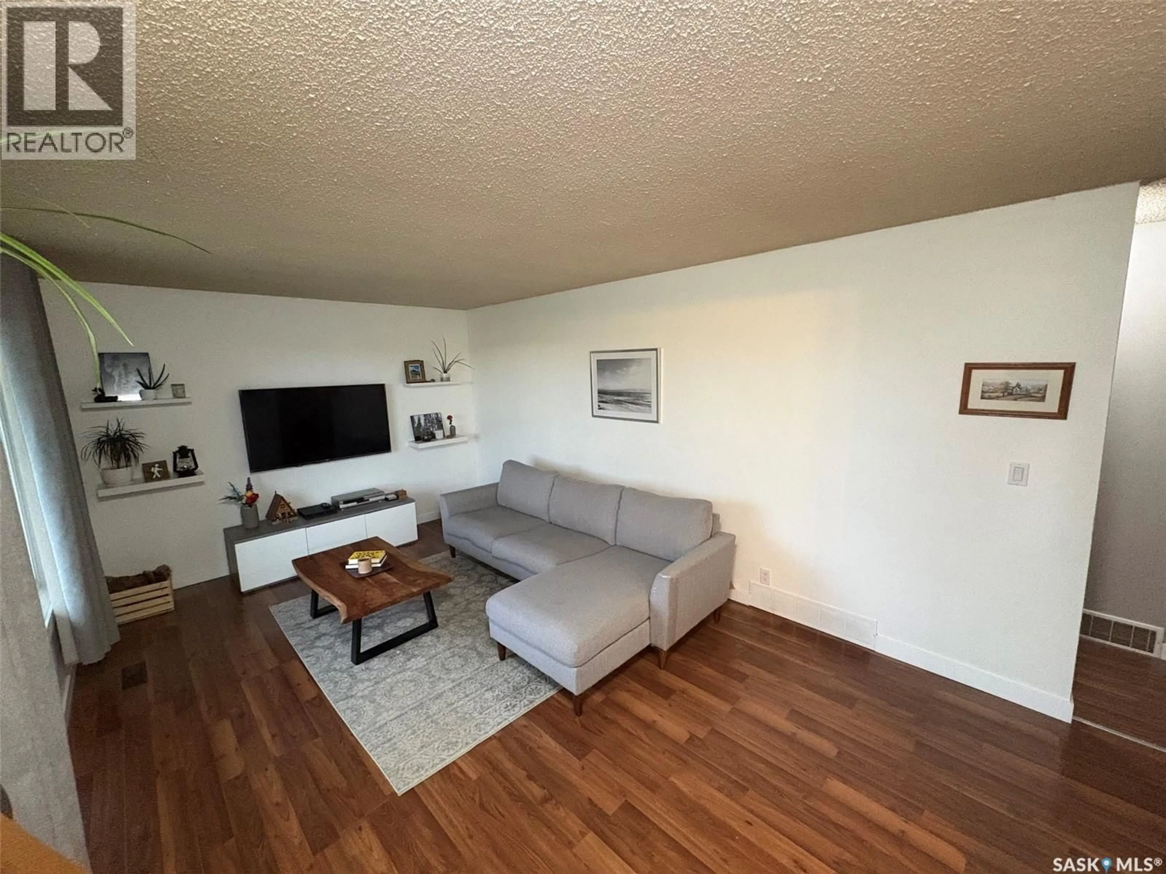 Living room with furniture, wood/laminate floor for 401 GOLSPIE STREET, Craik Saskatchewan S0G0V0