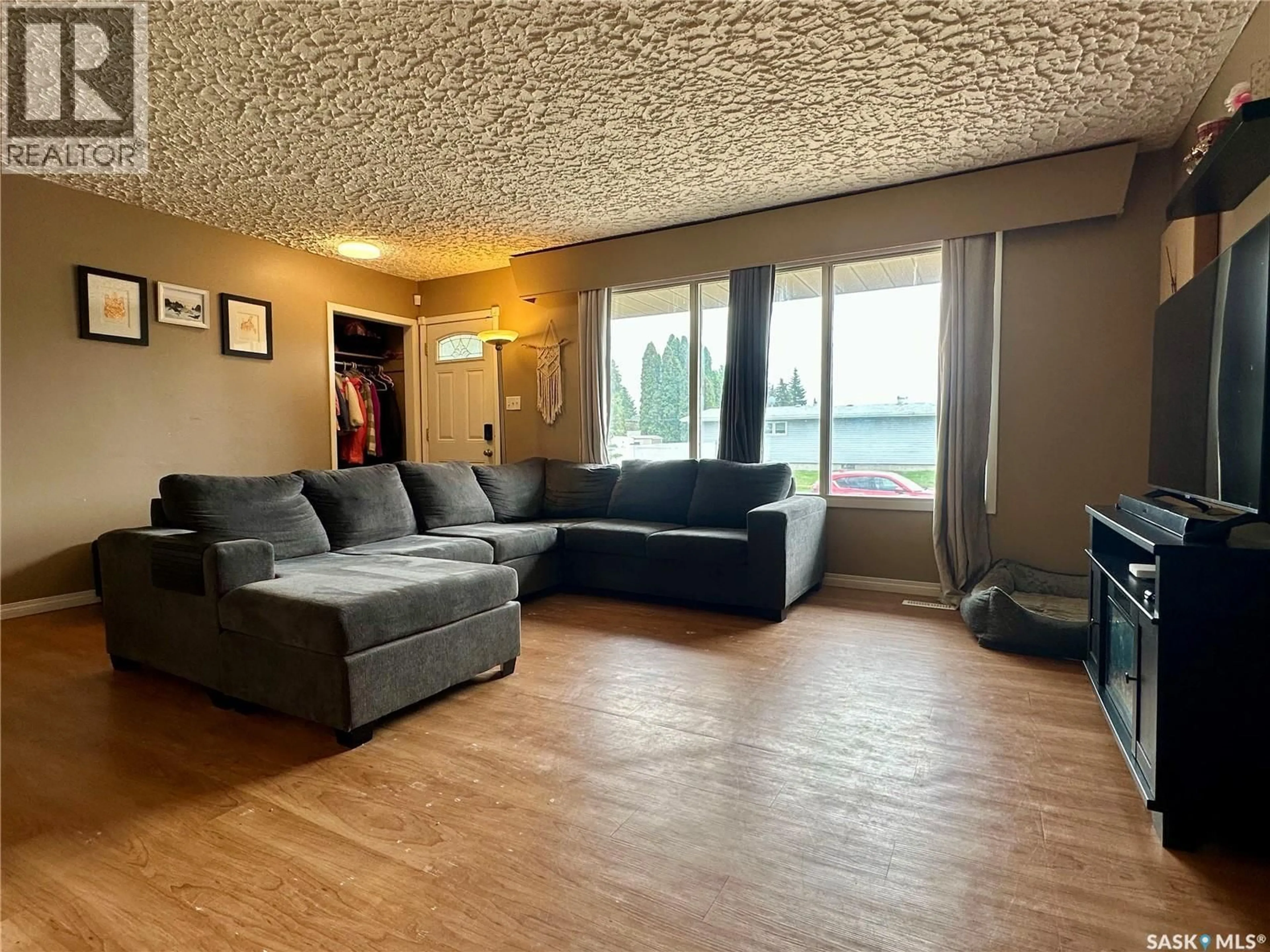 Living room with furniture, wood/laminate floor for 100 1ST STREET, Warman Saskatchewan S0K4S0