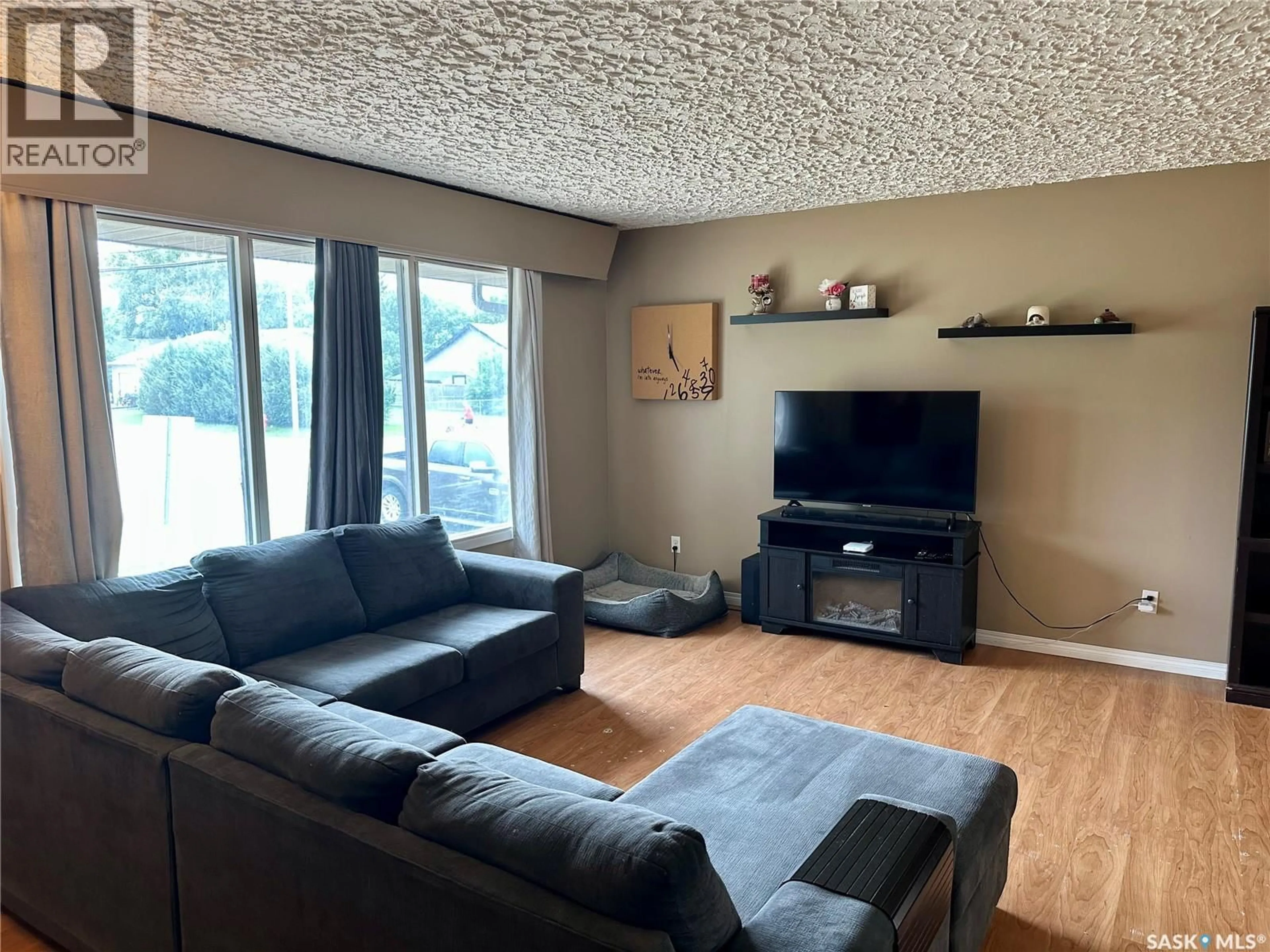 Living room with furniture, wood/laminate floor for 100 1ST STREET, Warman Saskatchewan S0K4S0