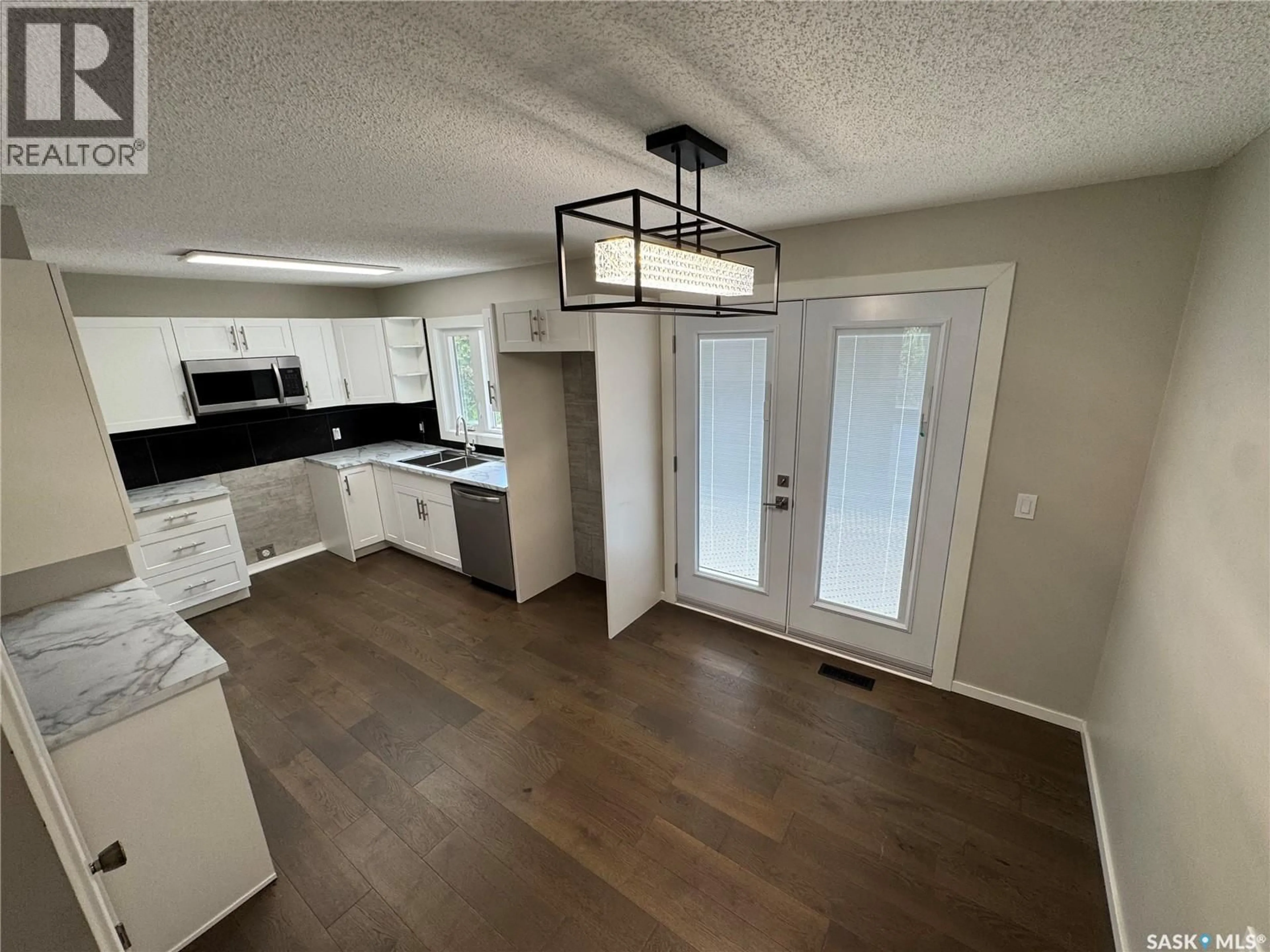 Open concept kitchen, wood/laminate floor for 7019 SHERWOOD DRIVE, Regina Saskatchewan S4X2V5