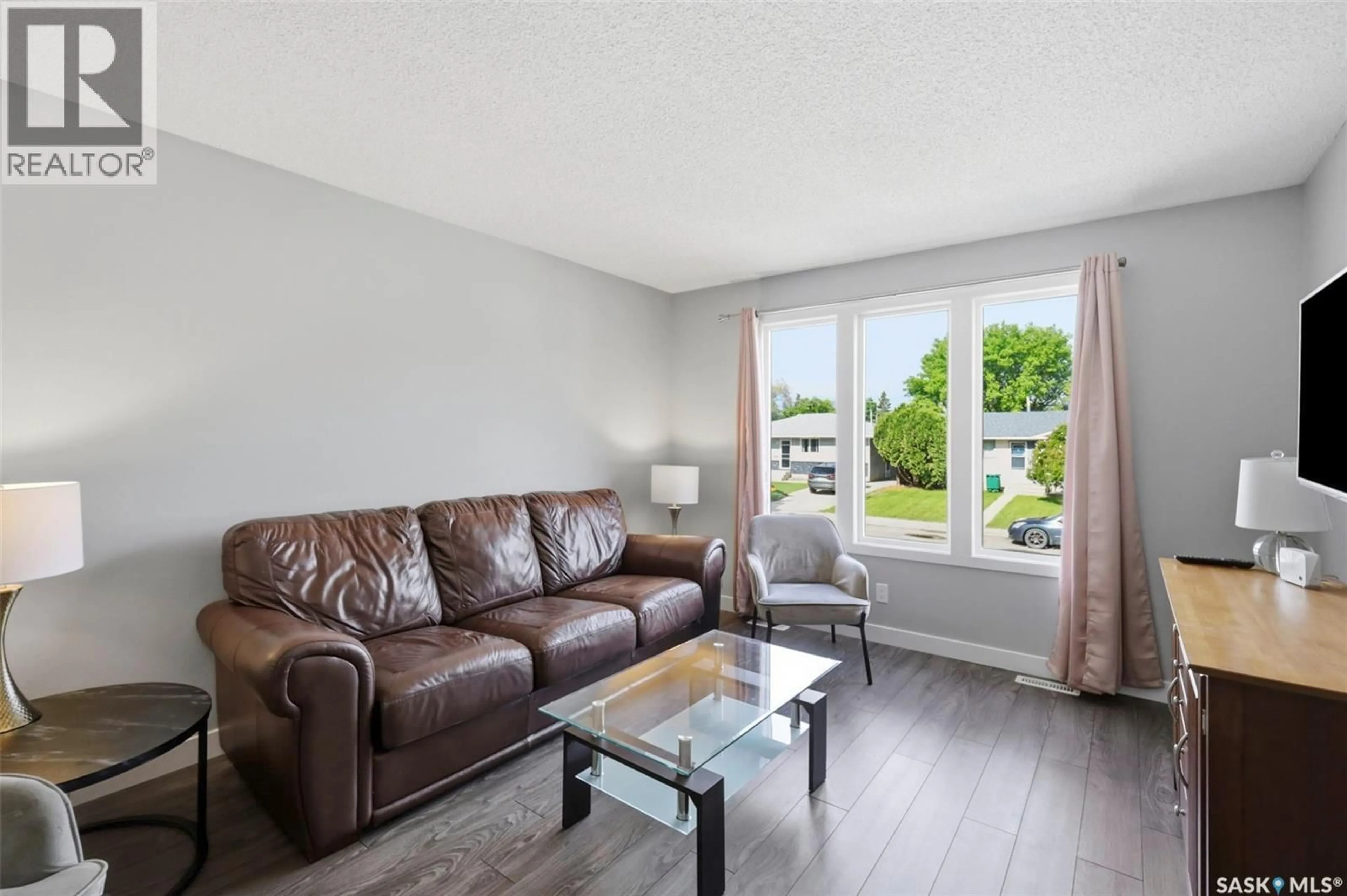 Living room with furniture, wood/laminate floor for 1521 LAURA AVENUE, Saskatoon Saskatchewan S7N2R8
