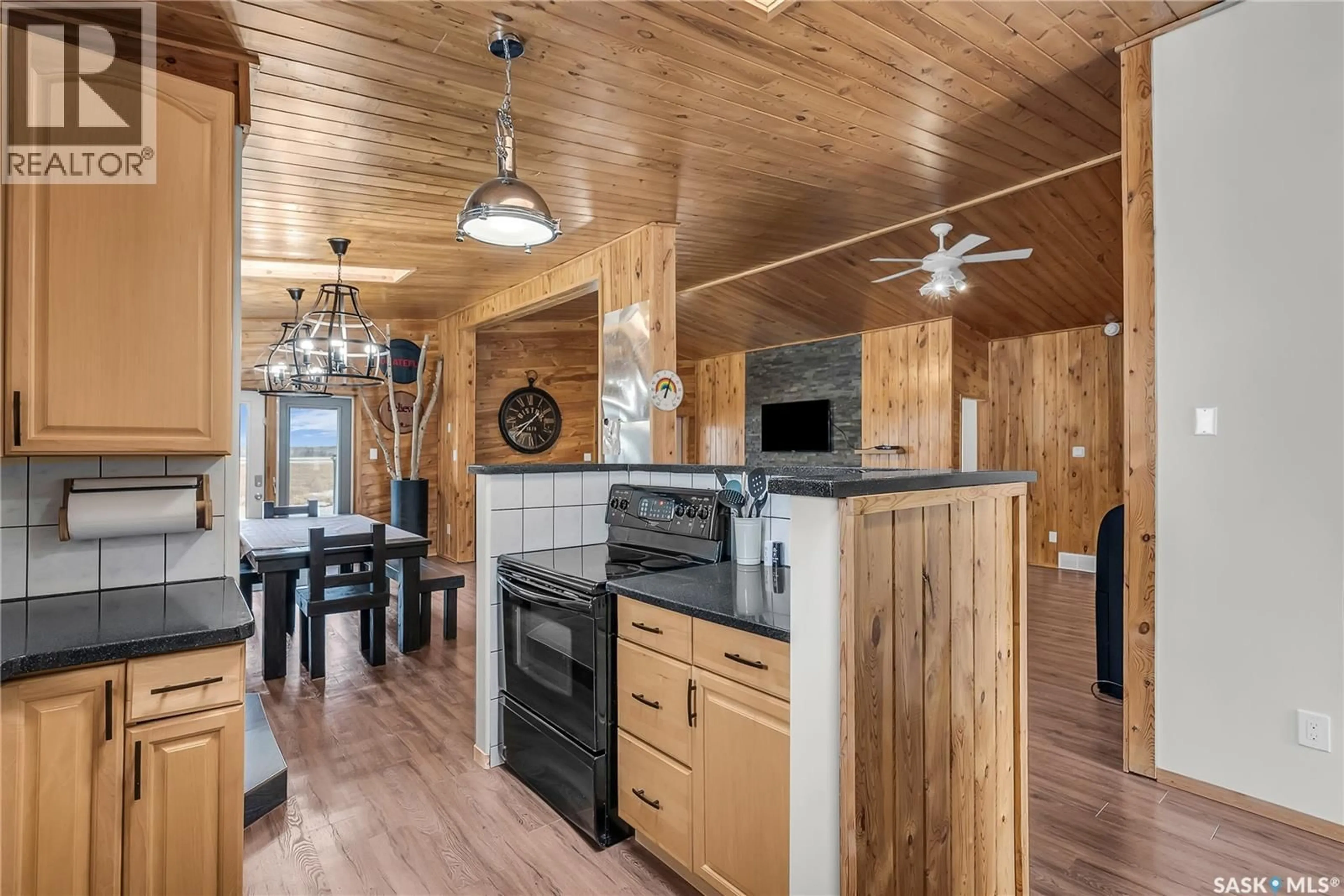 Open concept kitchen, wood/laminate floor for 108 IROQUOIS DRIVE, Iroquois Lake Saskatchewan S0J2G0