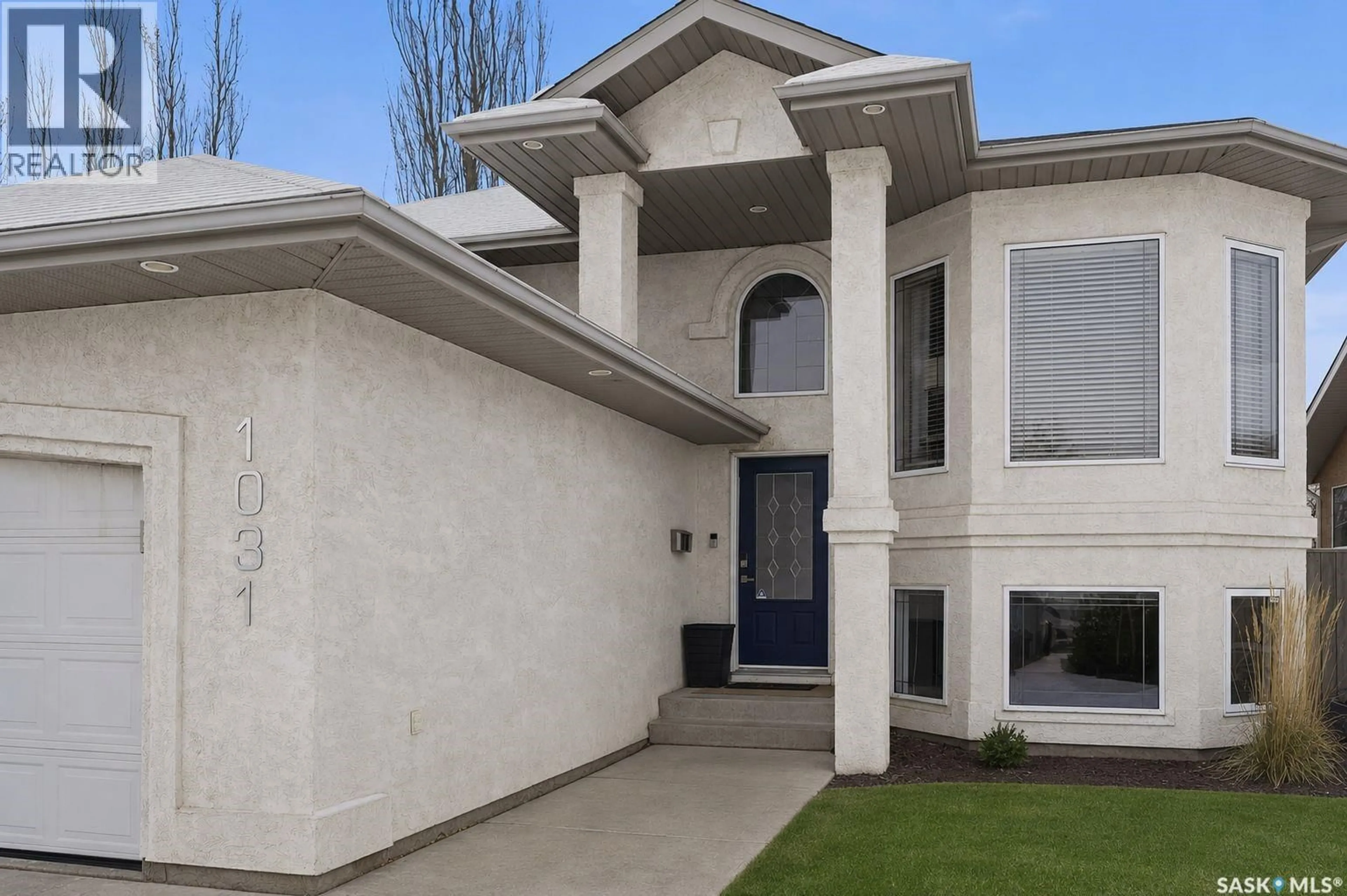 Home with vinyl exterior material, street for 1031 CARR CRESCENT, Saskatoon Saskatchewan S7S1L8