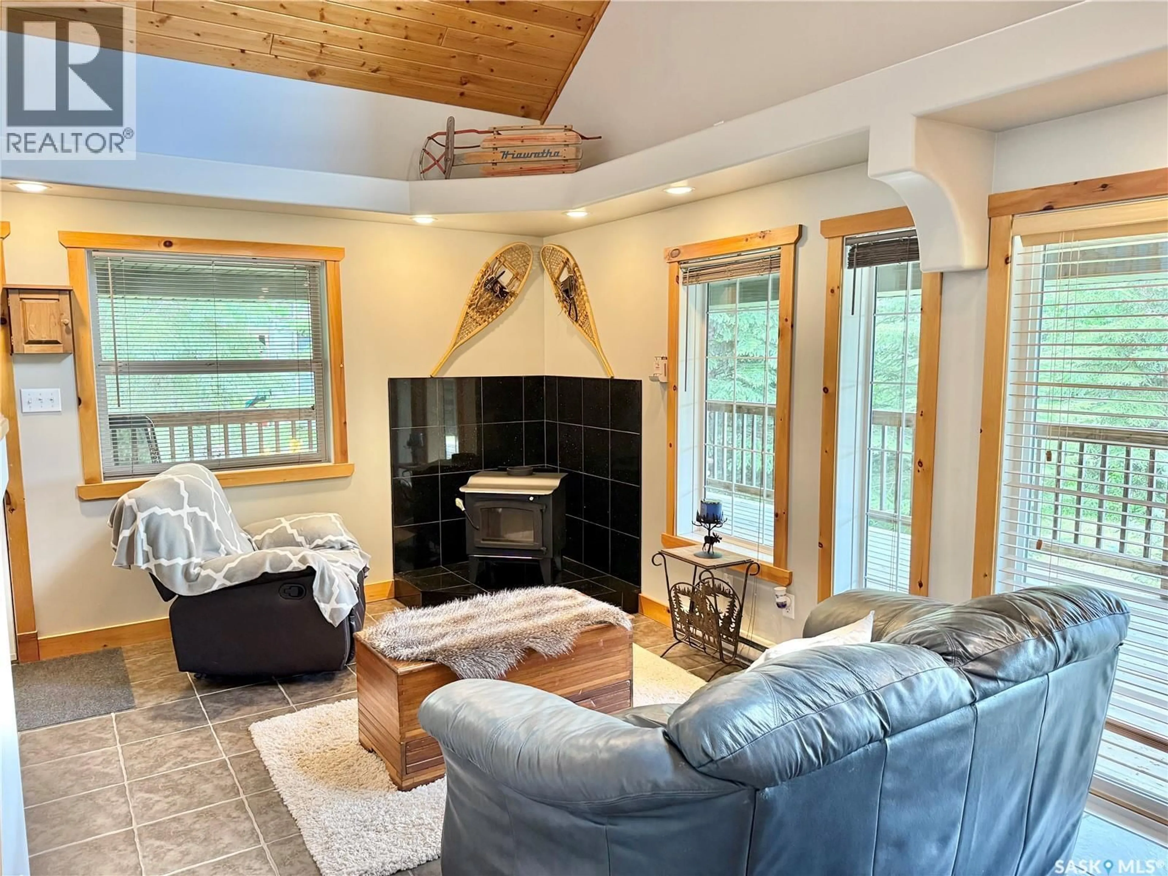 Living room with furniture, wood/laminate floor for 327 VENTURE ROAD, Pebble Baye Saskatchewan S0J2G0