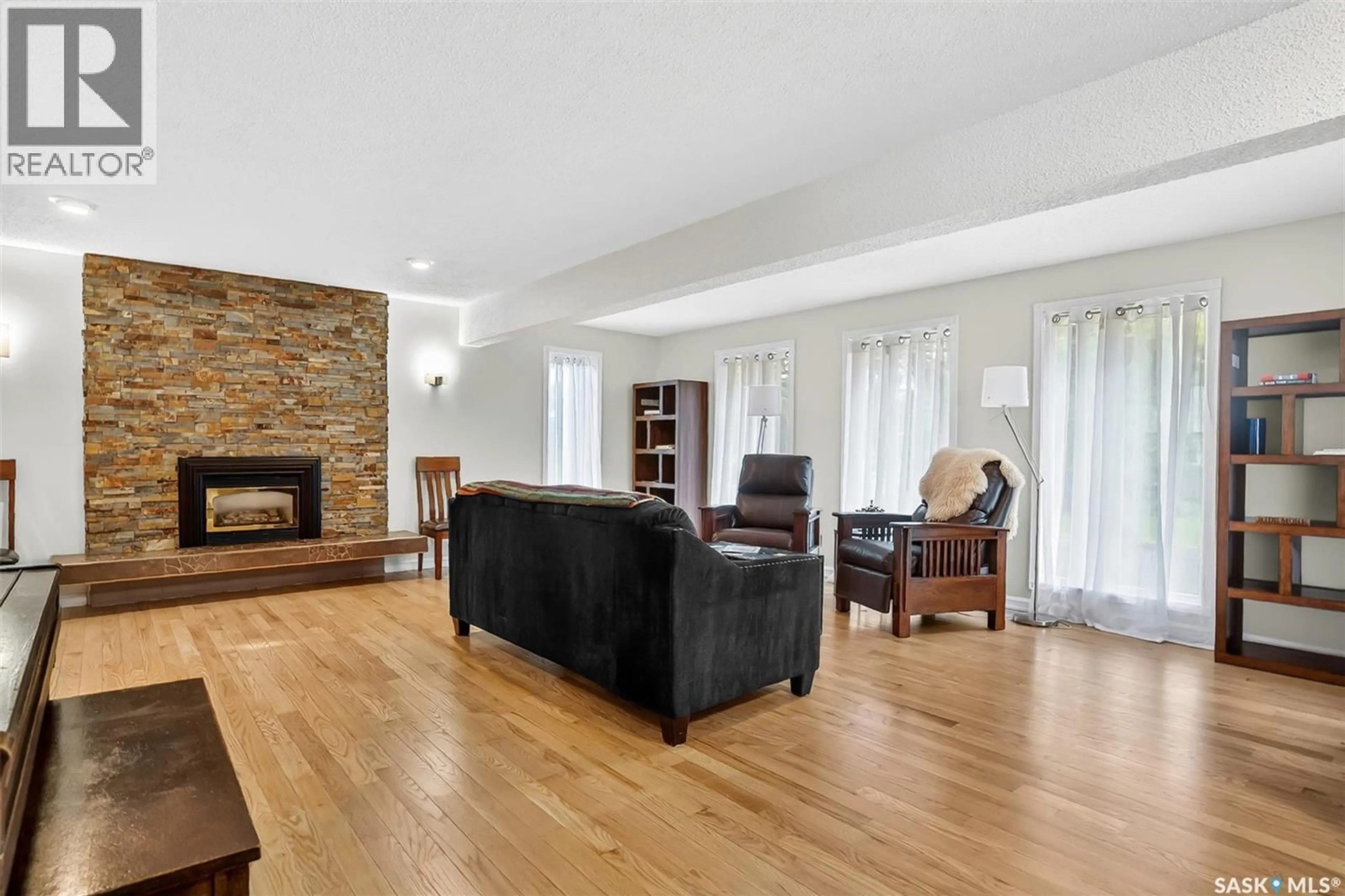 Living room with furniture, wood/laminate floor for 3445 CAEN STREET, Saskatoon Saskatchewan S7M3P5