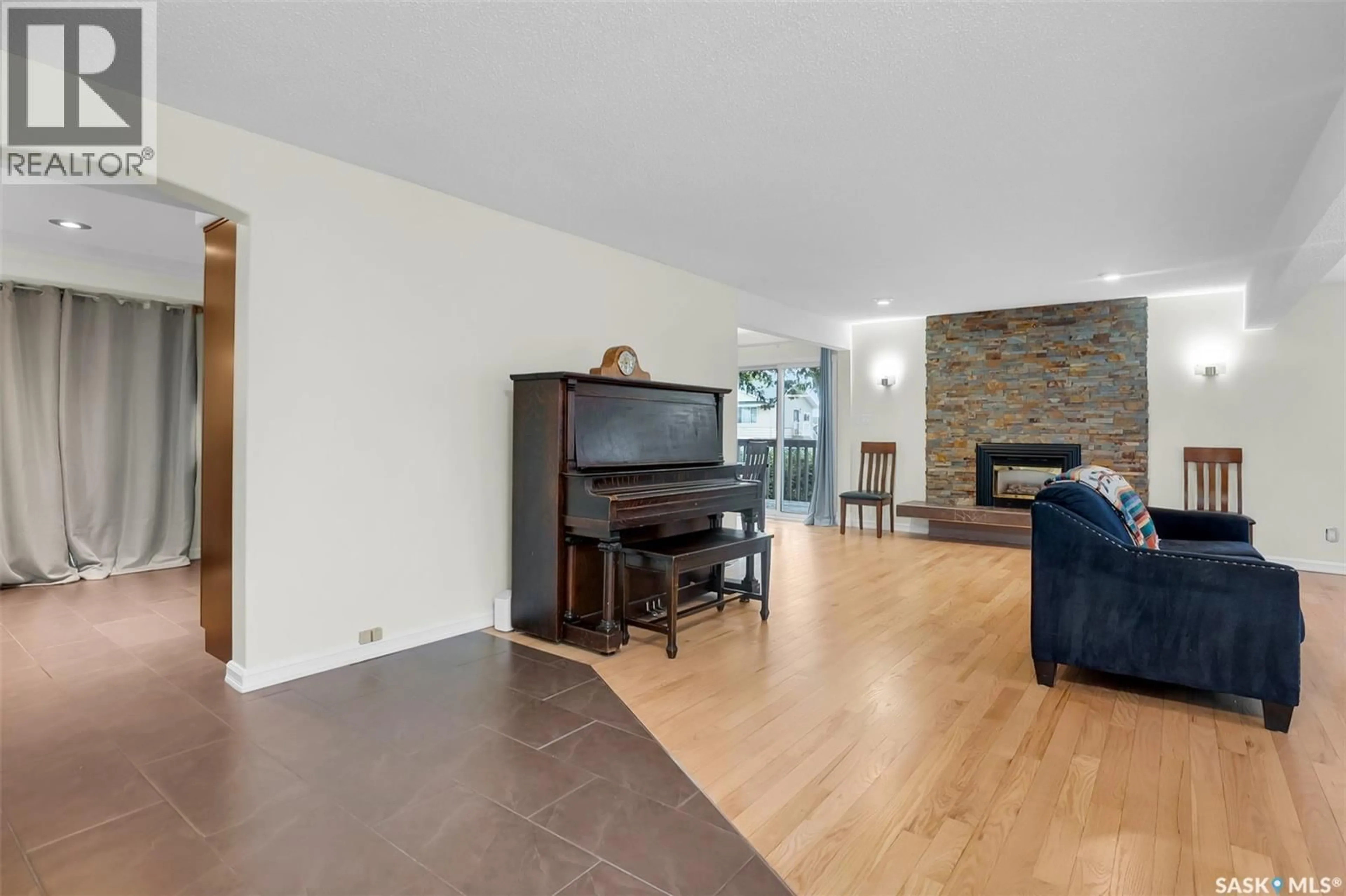 Living room with furniture, wood/laminate floor for 3445 CAEN STREET, Saskatoon Saskatchewan S7M3P5