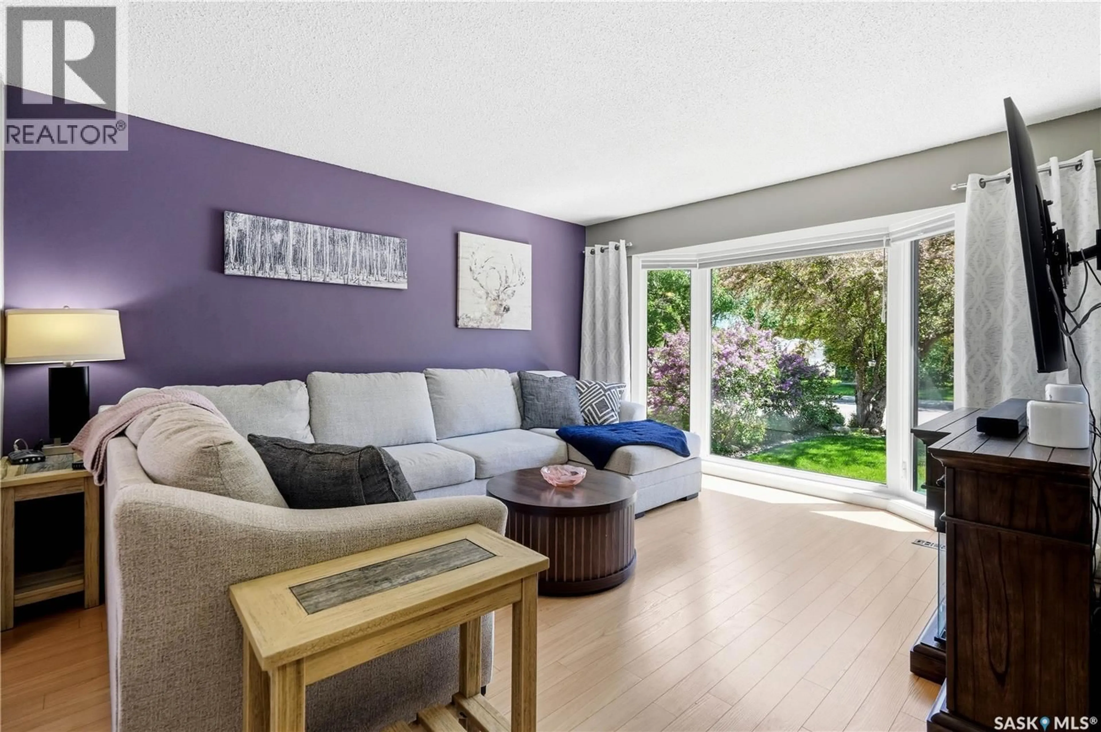 Living room with furniture, wood/laminate floor for 179 MERLIN CRESCENT, Regina Saskatchewan S4R3E6