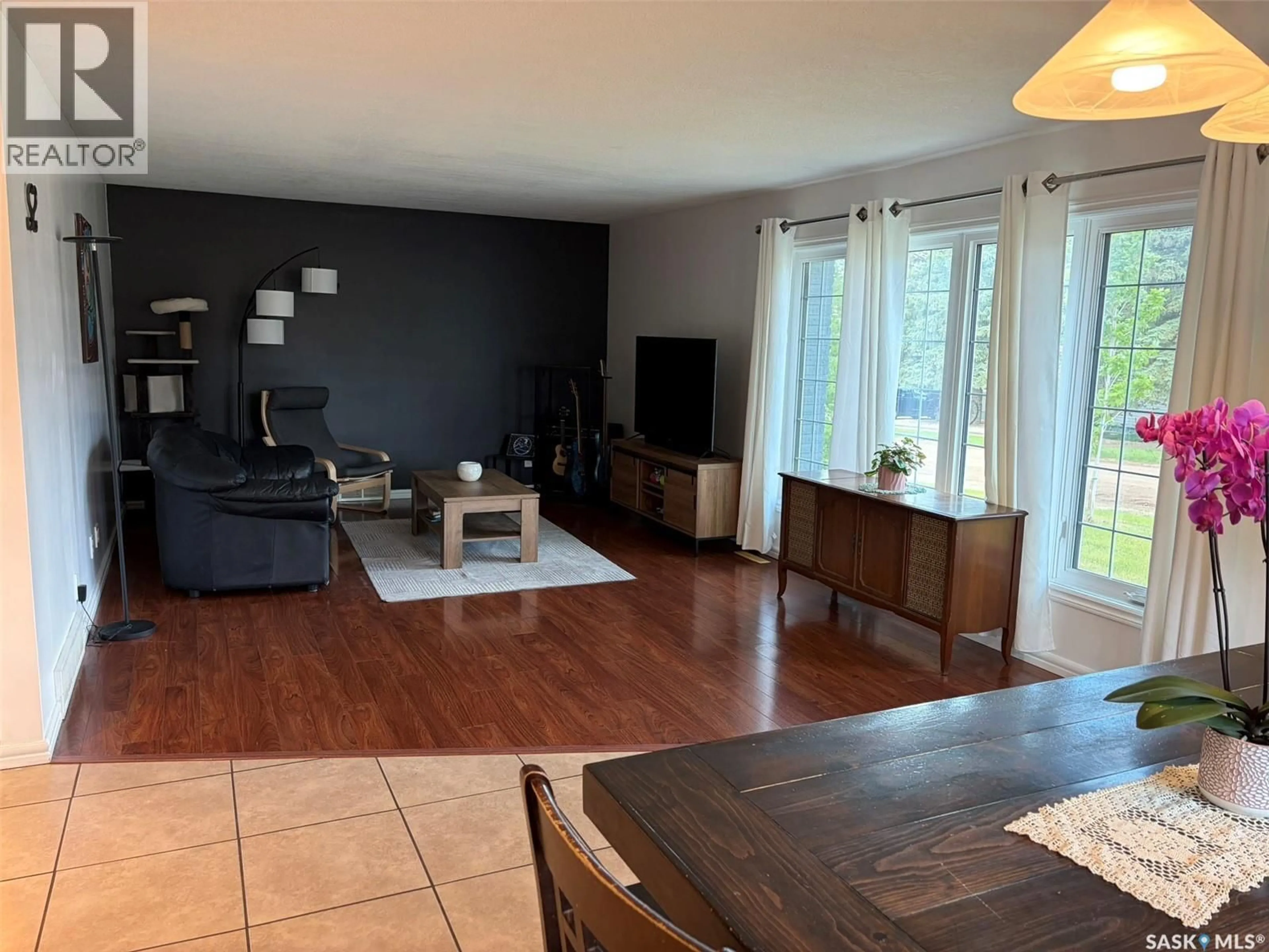Living room with furniture, wood/laminate floor for E - 105 5TH STREET, Birch Hills Saskatchewan S0J0G0