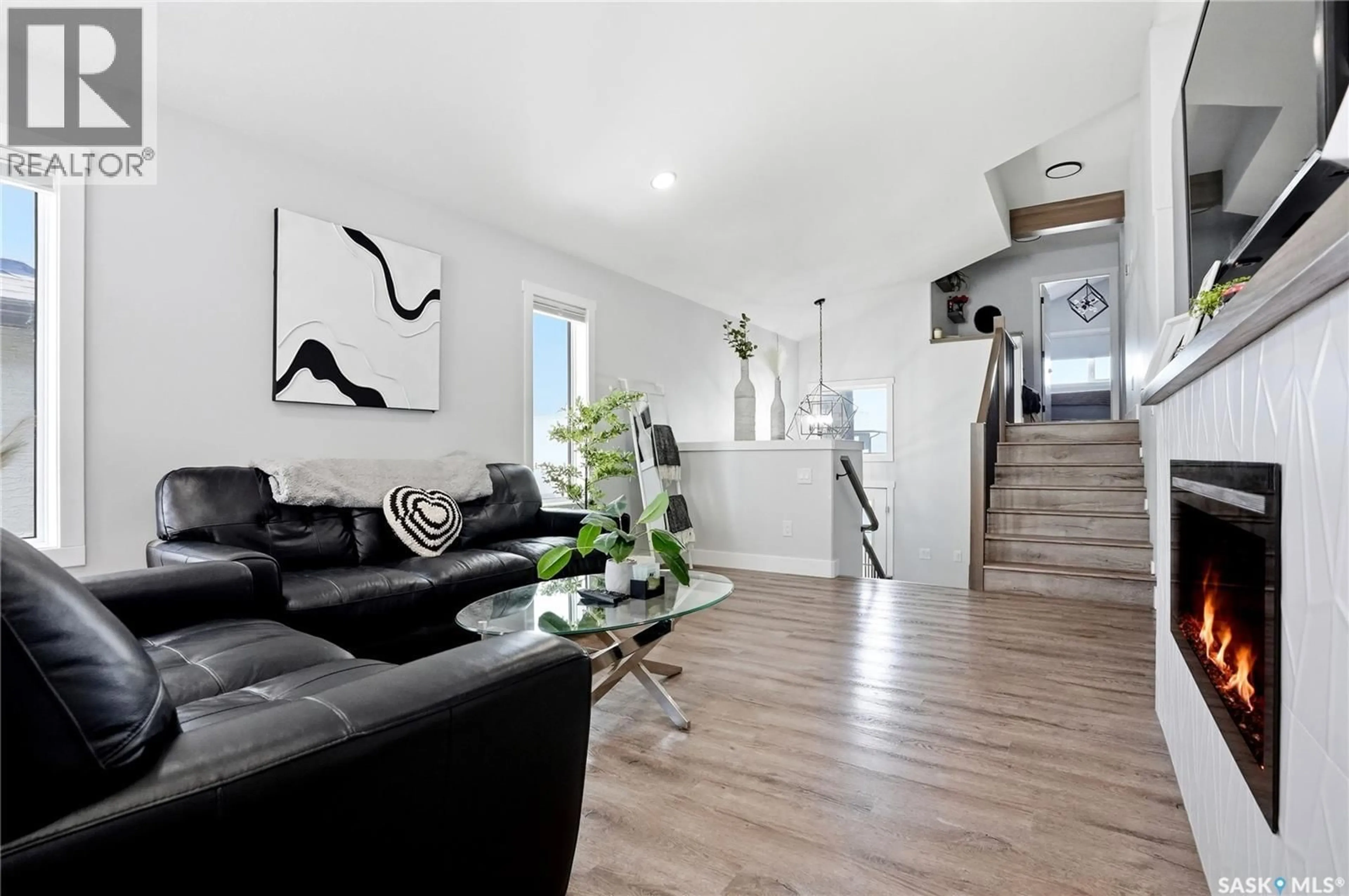 Living room with furniture, wood/laminate floor for 172 THAKUR STREET, Saskatoon Saskatchewan S7W1C4