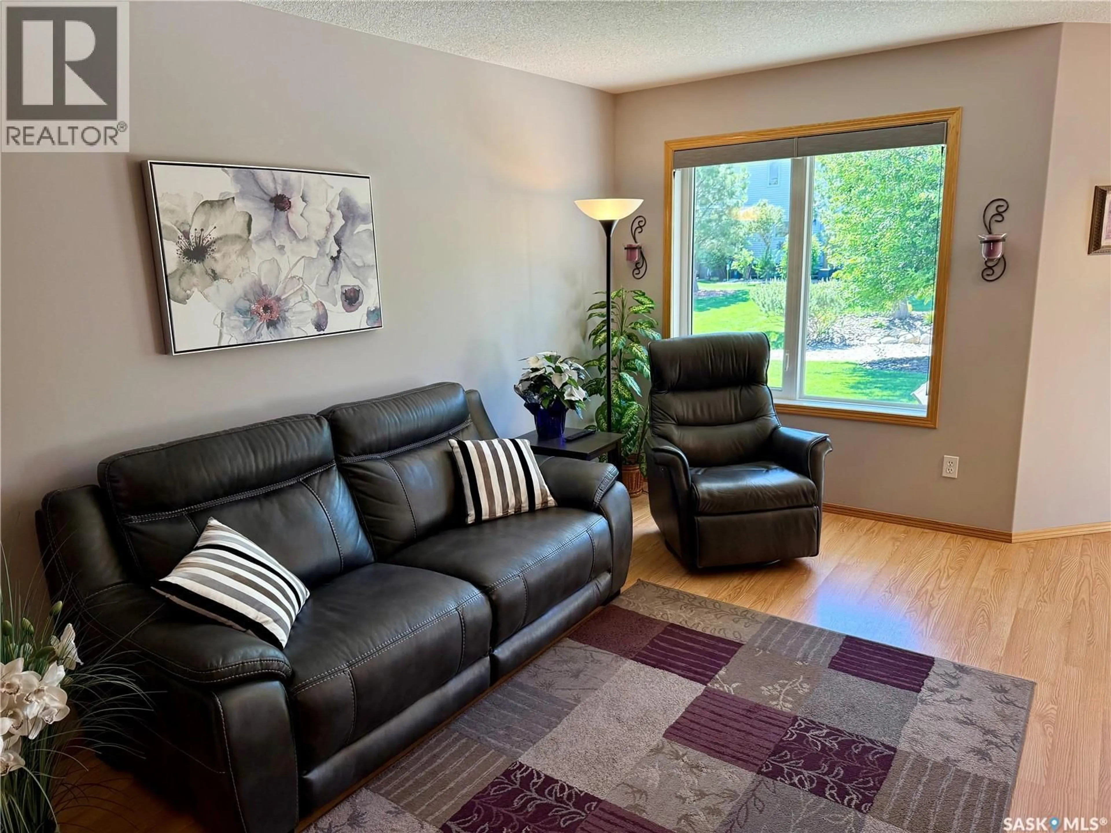 Living room with furniture, wood/laminate floor for 223 MIKKELSON DRIVE, Regina Saskatchewan S4T0A3