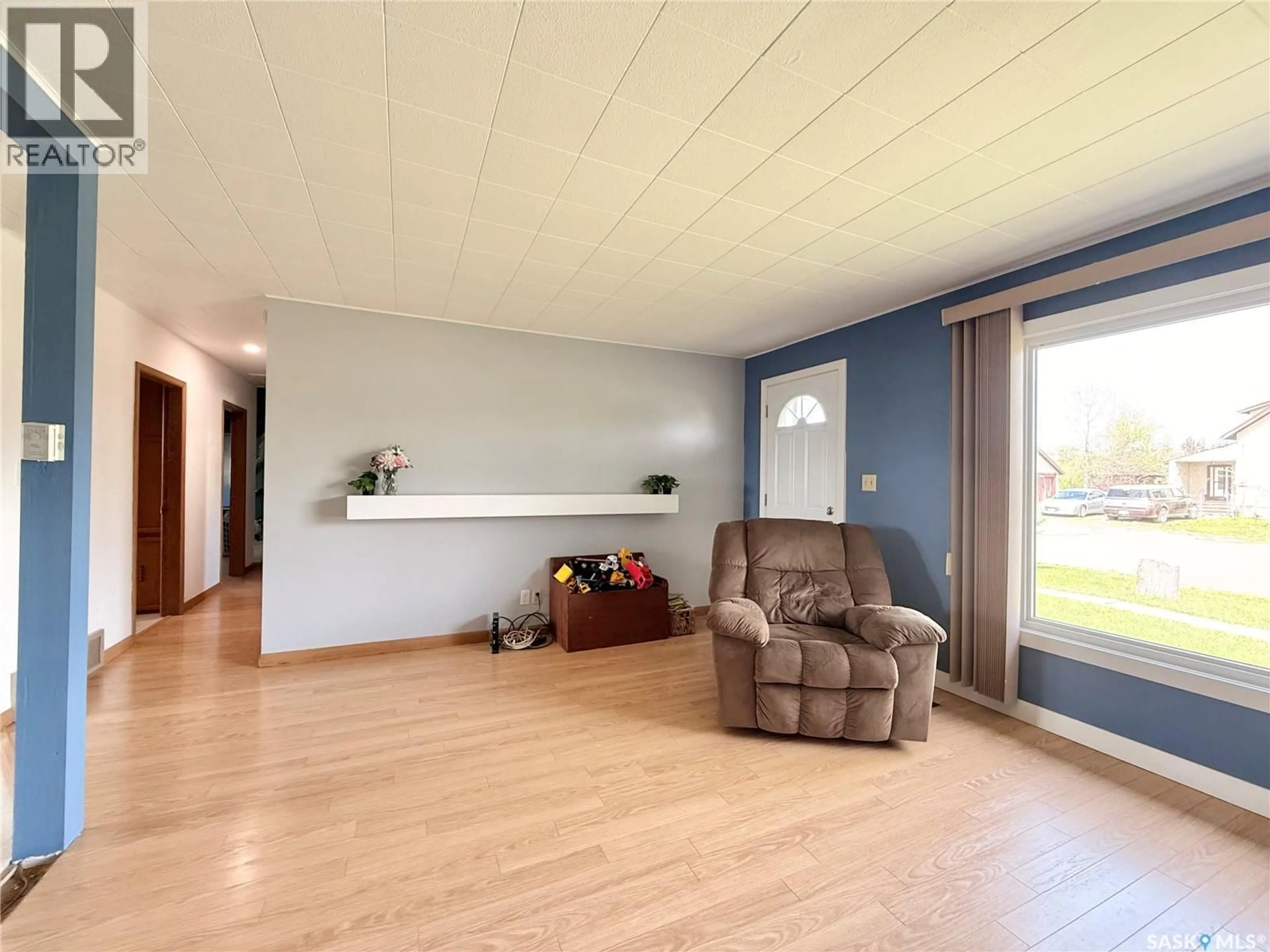 Living room with furniture, wood/laminate floor for 200 2ND STREET, Dinsmore Saskatchewan S0L0T0