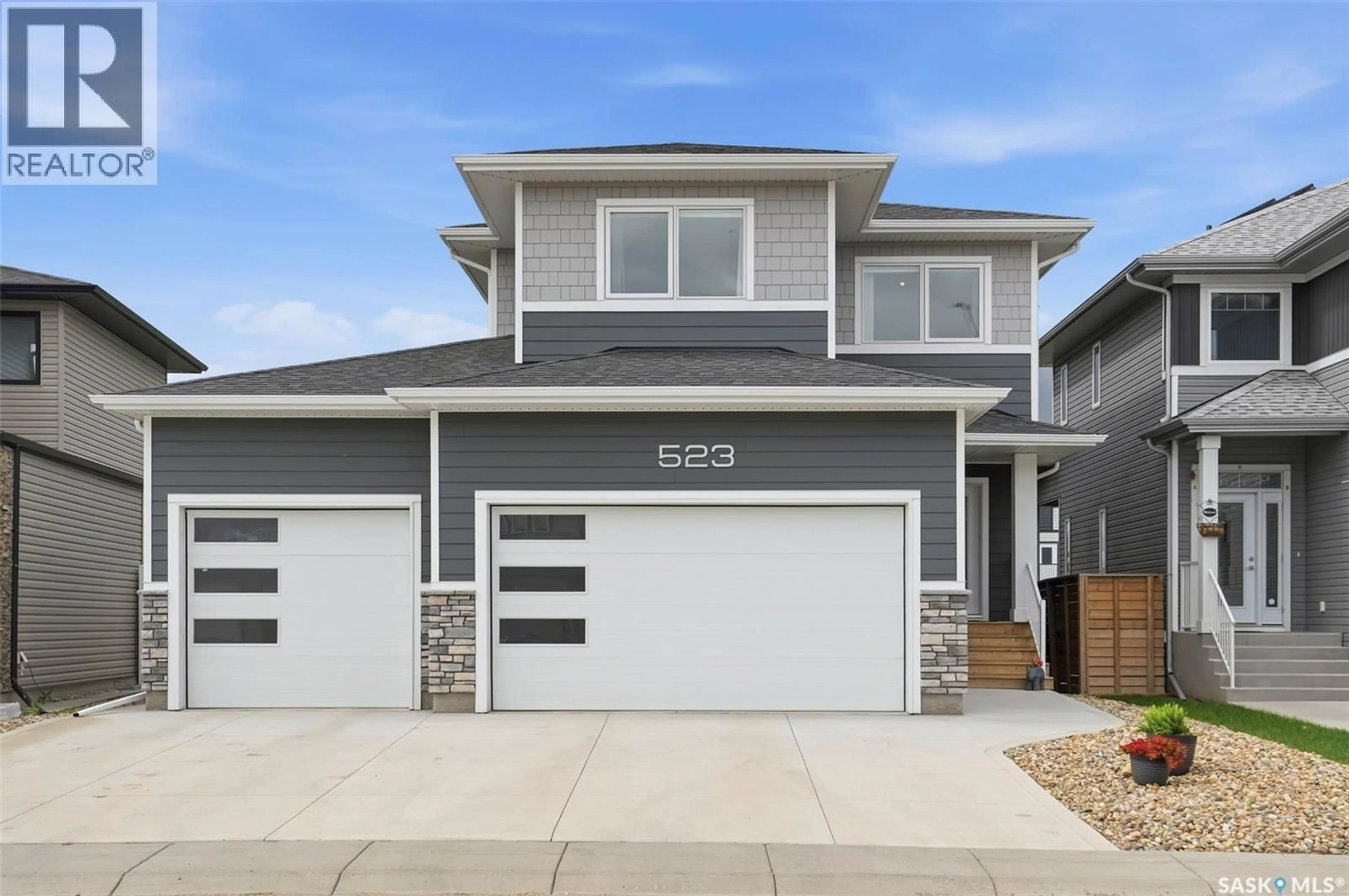 Home with vinyl exterior material, street for 523 BOLSTAD TURN, Saskatoon Saskatchewan S7W0X9