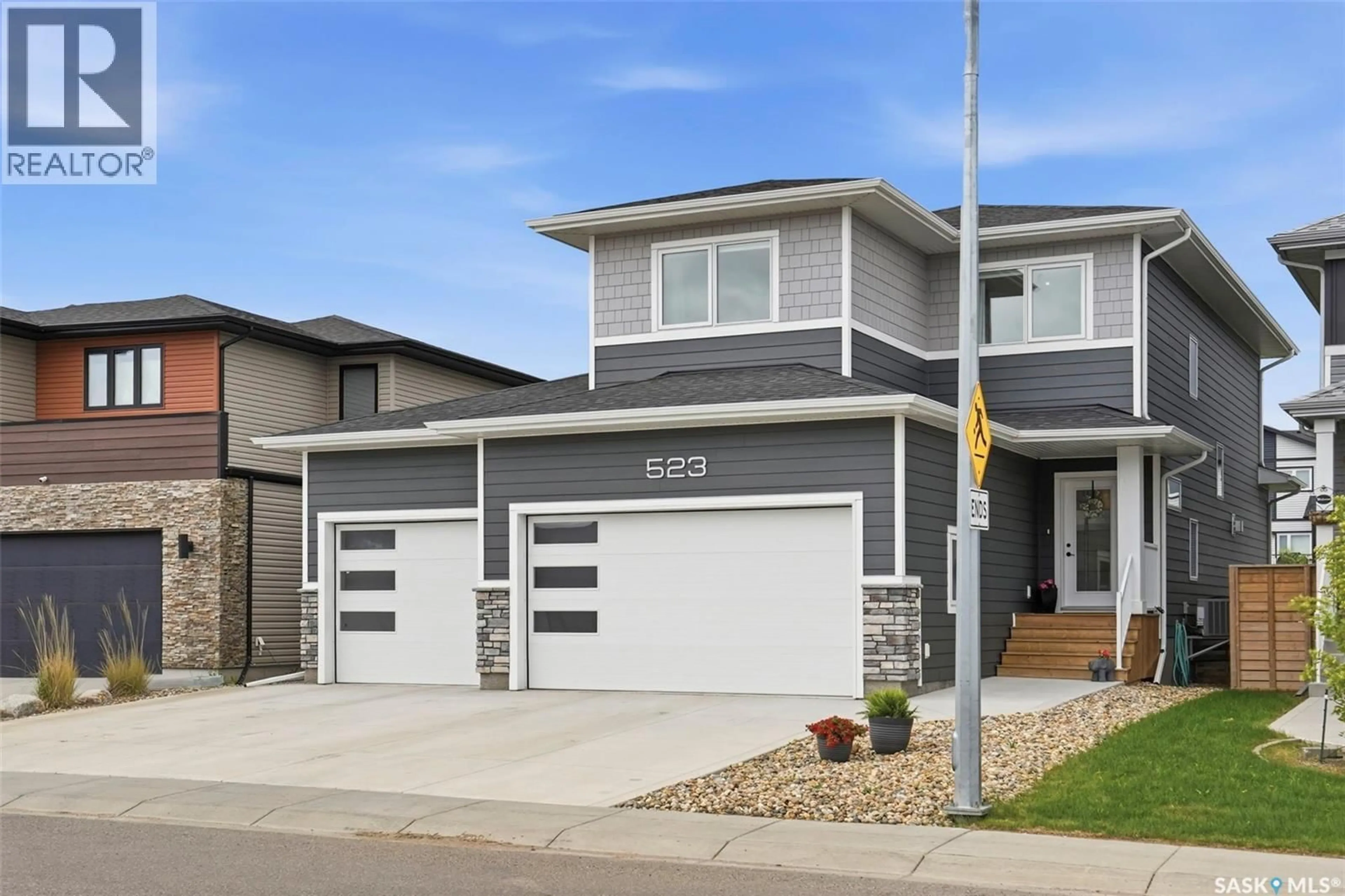 Home with vinyl exterior material, street for 523 BOLSTAD TURN, Saskatoon Saskatchewan S7W0X9