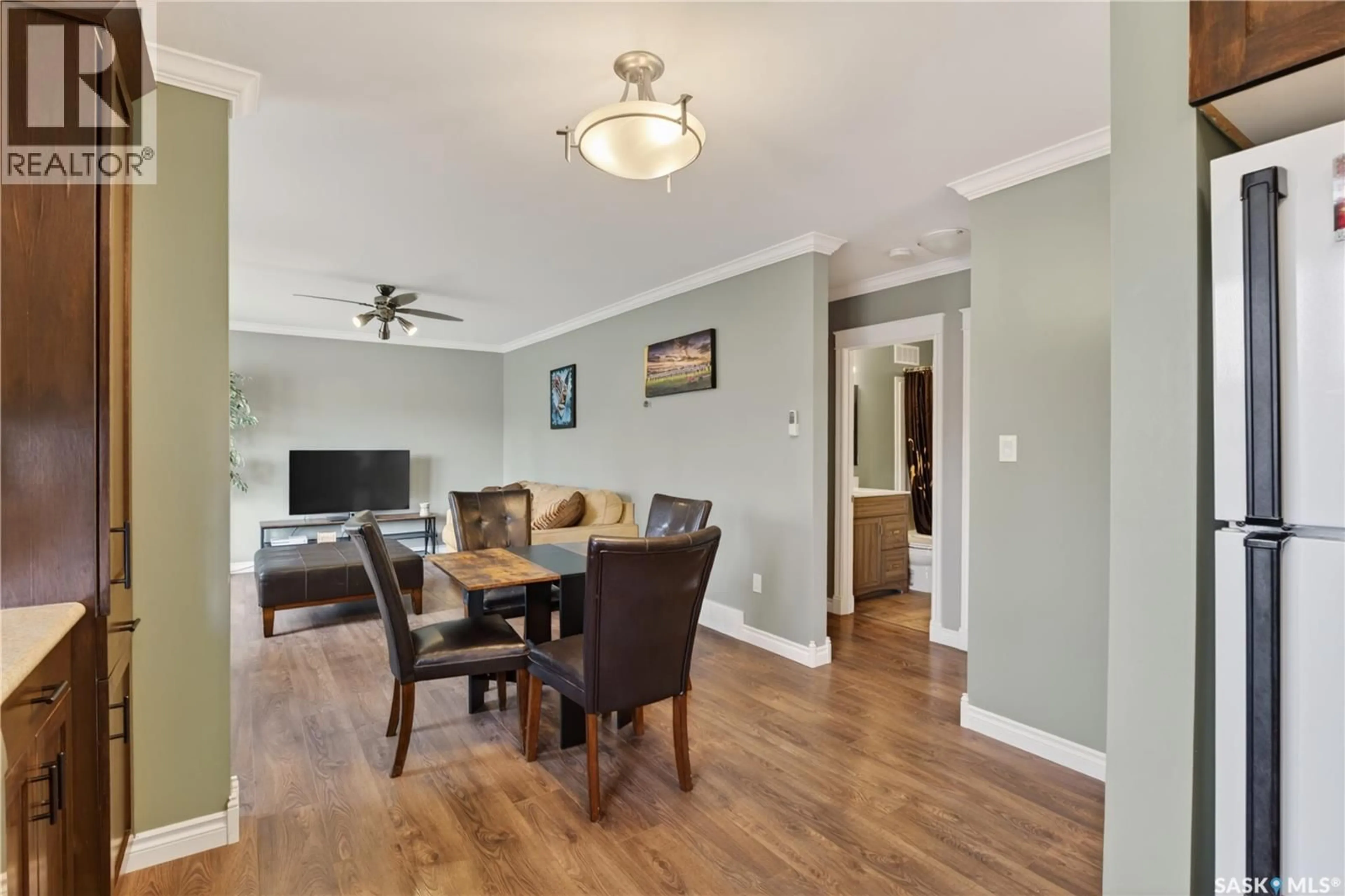 Living room with furniture, wood/laminate floor for 716 3RD STREET, Humboldt Saskatchewan S0K2A0