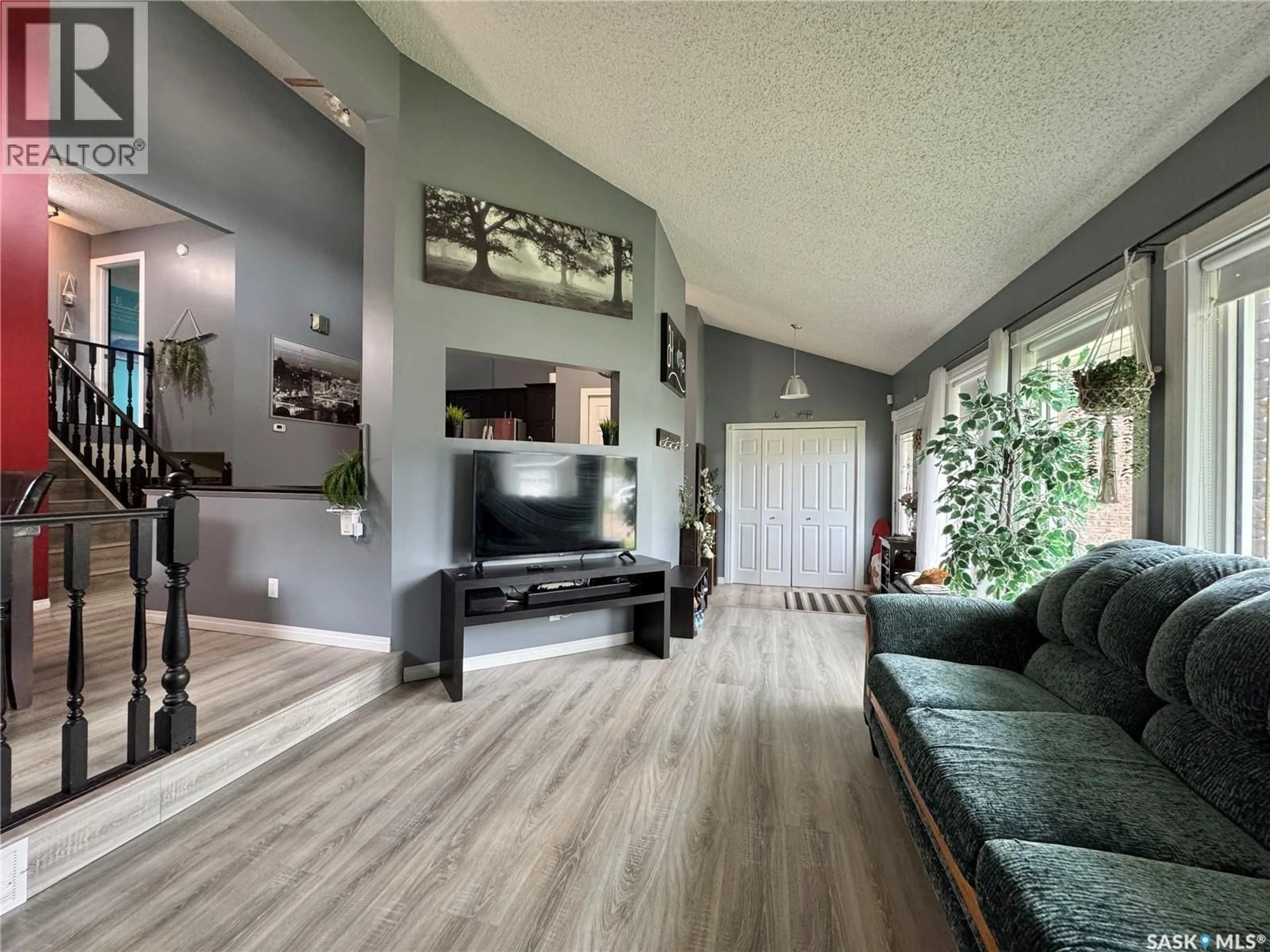 Living room with furniture, wood/laminate floor for 31 LANGRILL DRIVE, Yorkton Saskatchewan S3N3M9