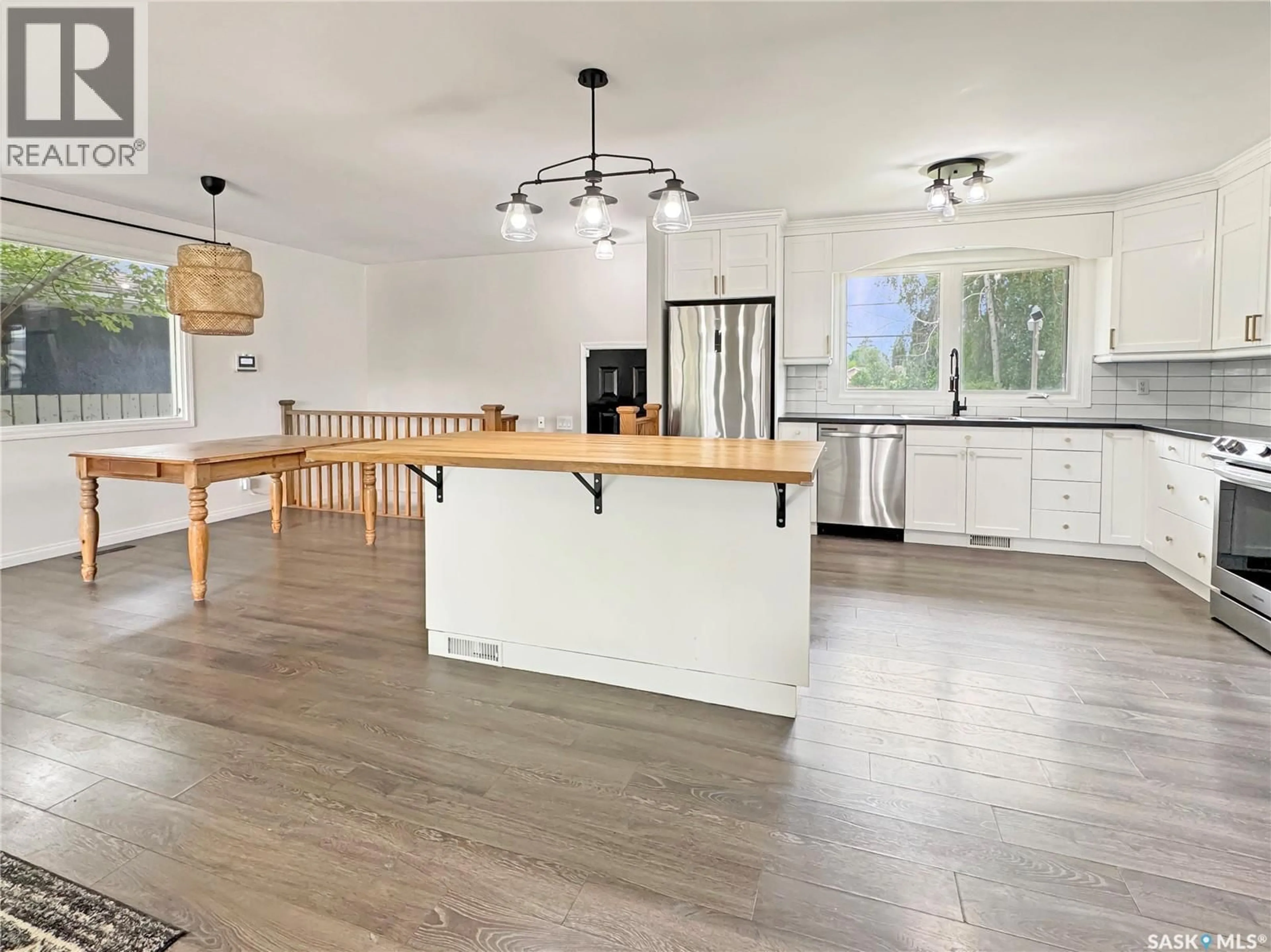 Open concept kitchen, wood/laminate floor for 1661 91ST STREET, North Battleford Saskatchewan S9A0A3