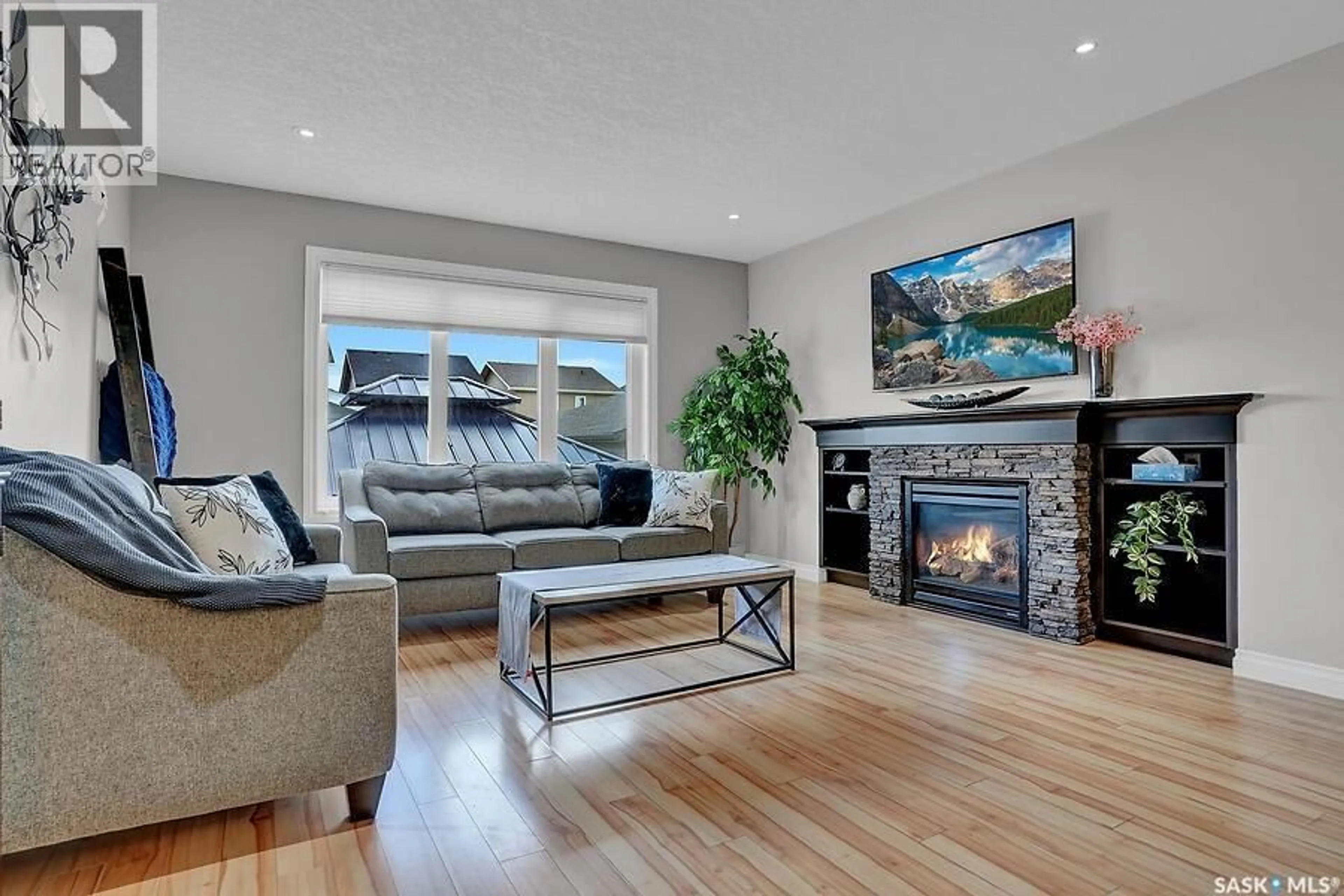 Living room with furniture, wood/laminate floor for 8705 HINCKS LANE, Regina Saskatchewan S4Y0B9