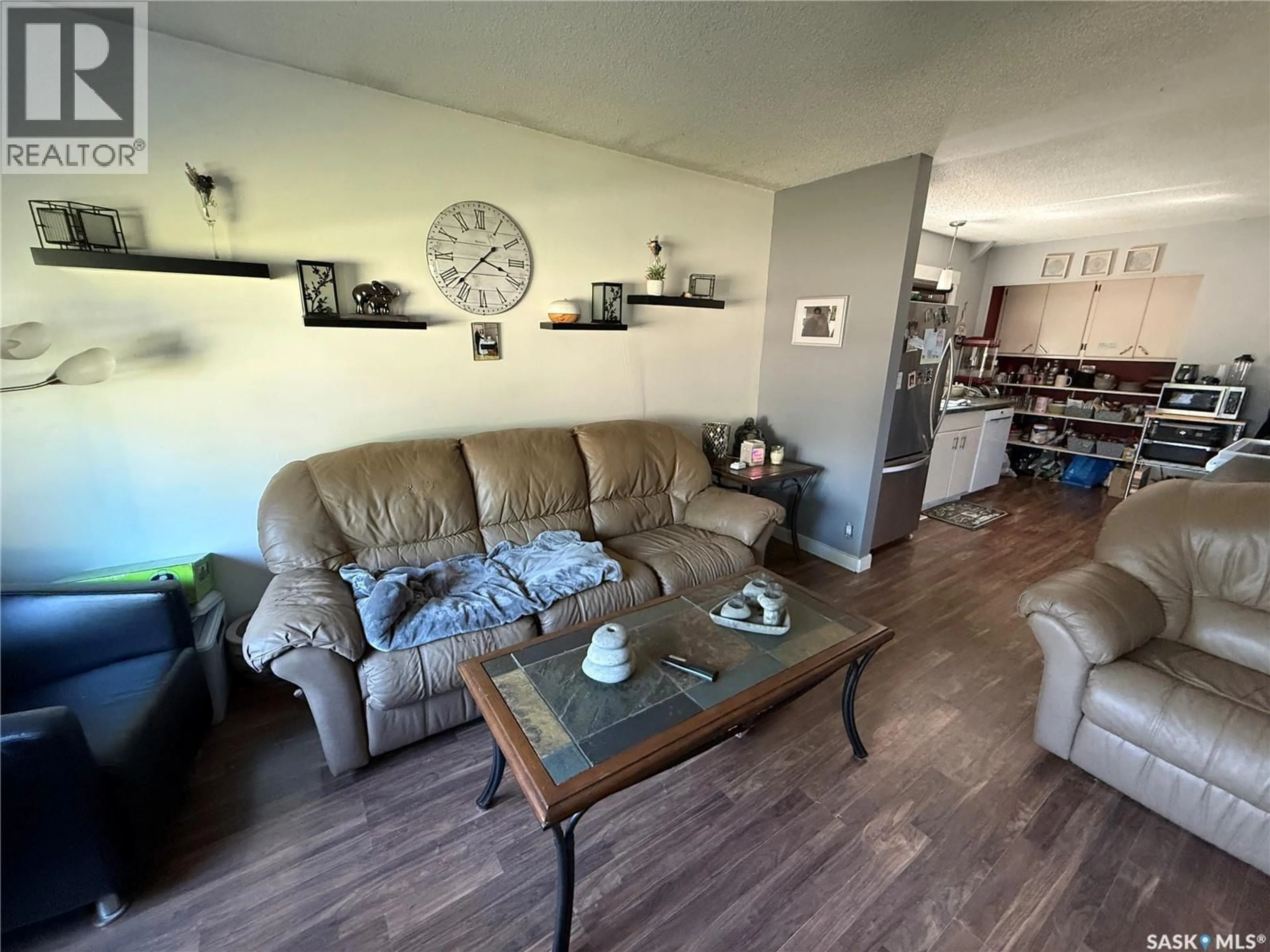 Living room with furniture, wood/laminate floor for 103 4TH AVENUE, Weyburn Saskatchewan S4H1X7