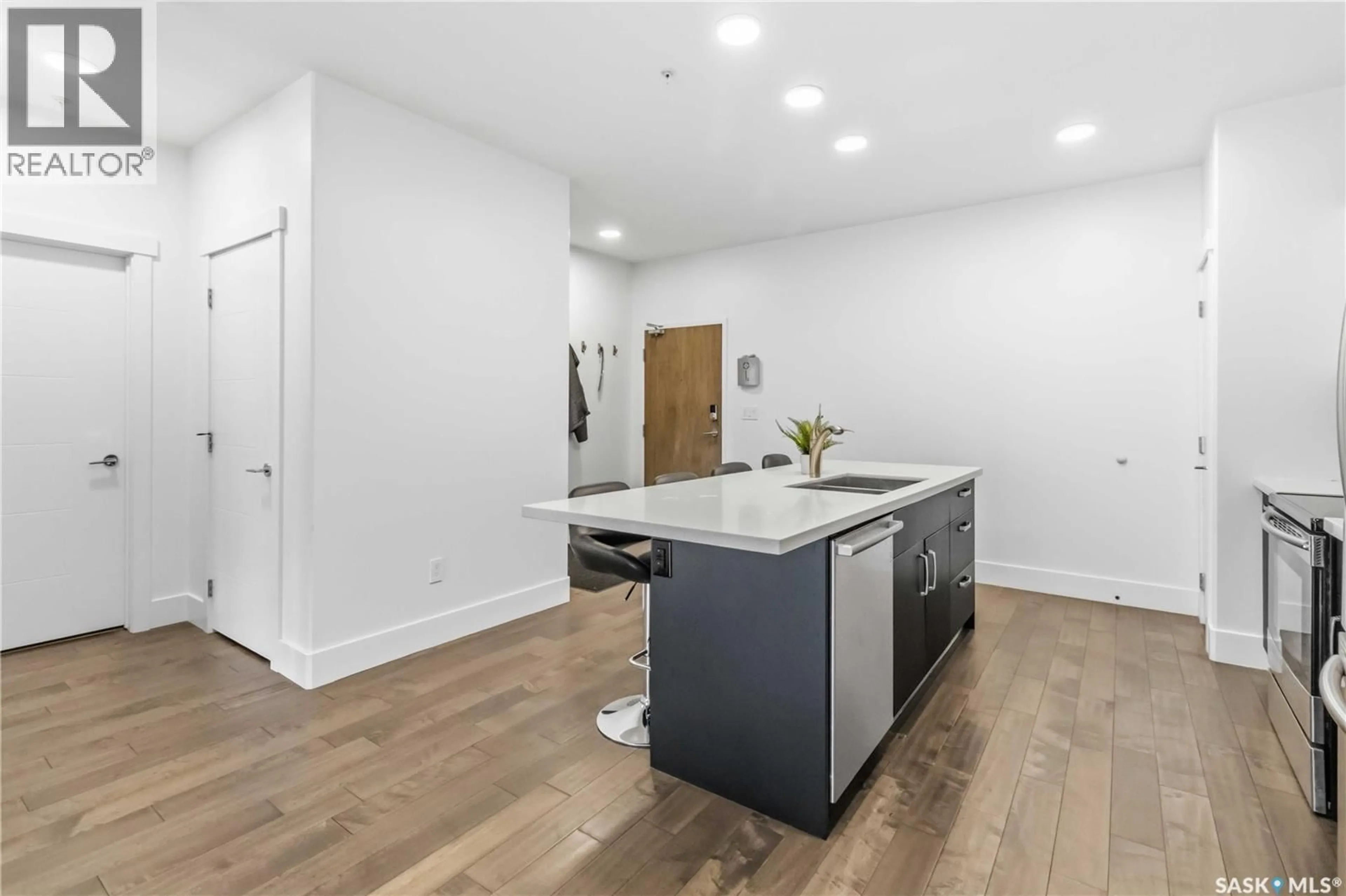 Open concept kitchen, wood/laminate floor for 104 - 1010 MAIN STREET, Saskatoon Saskatchewan S7H0K7