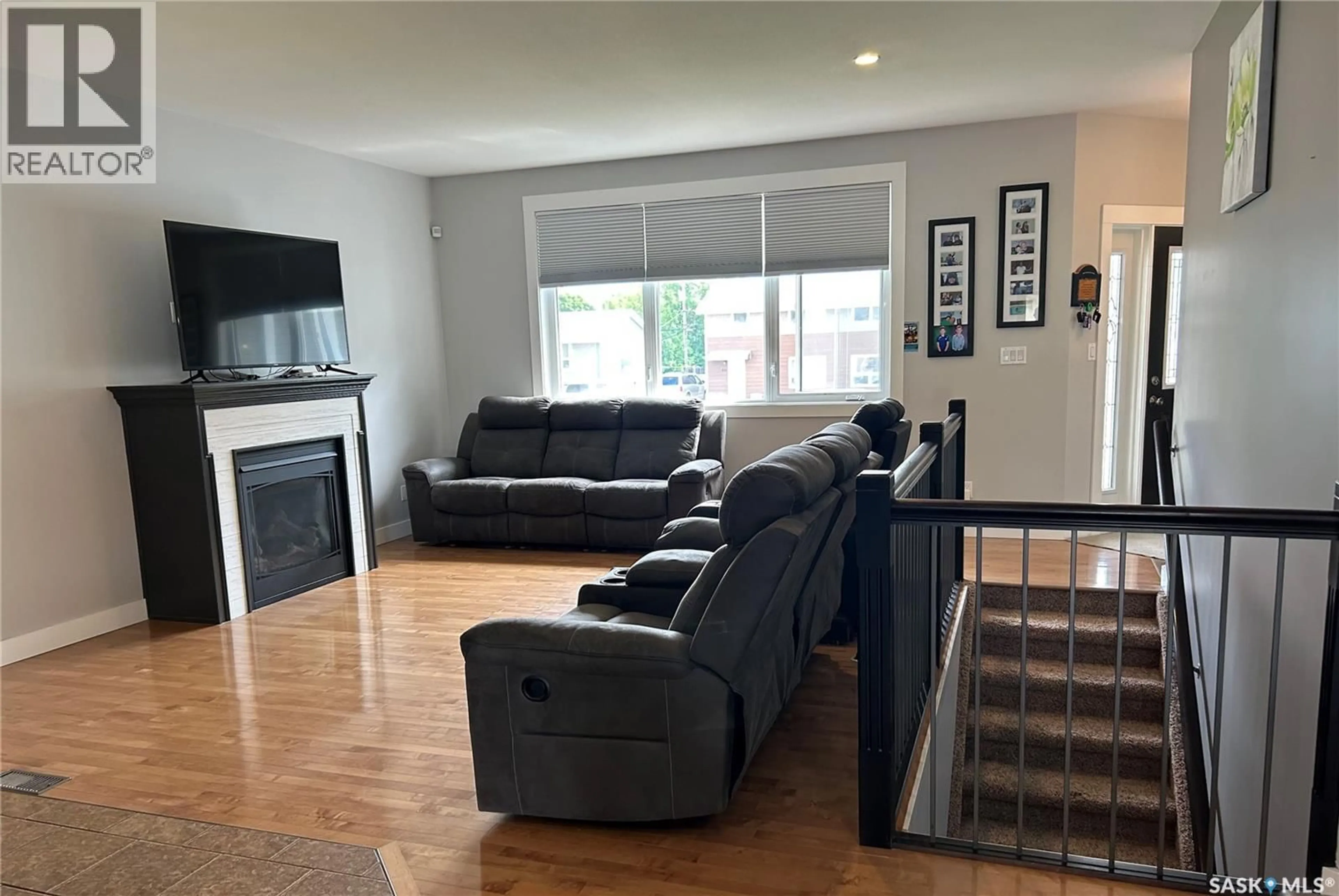 Living room with furniture, wood/laminate floor for 832 7TH AVENUE, Moose Jaw Saskatchewan S6H1M7