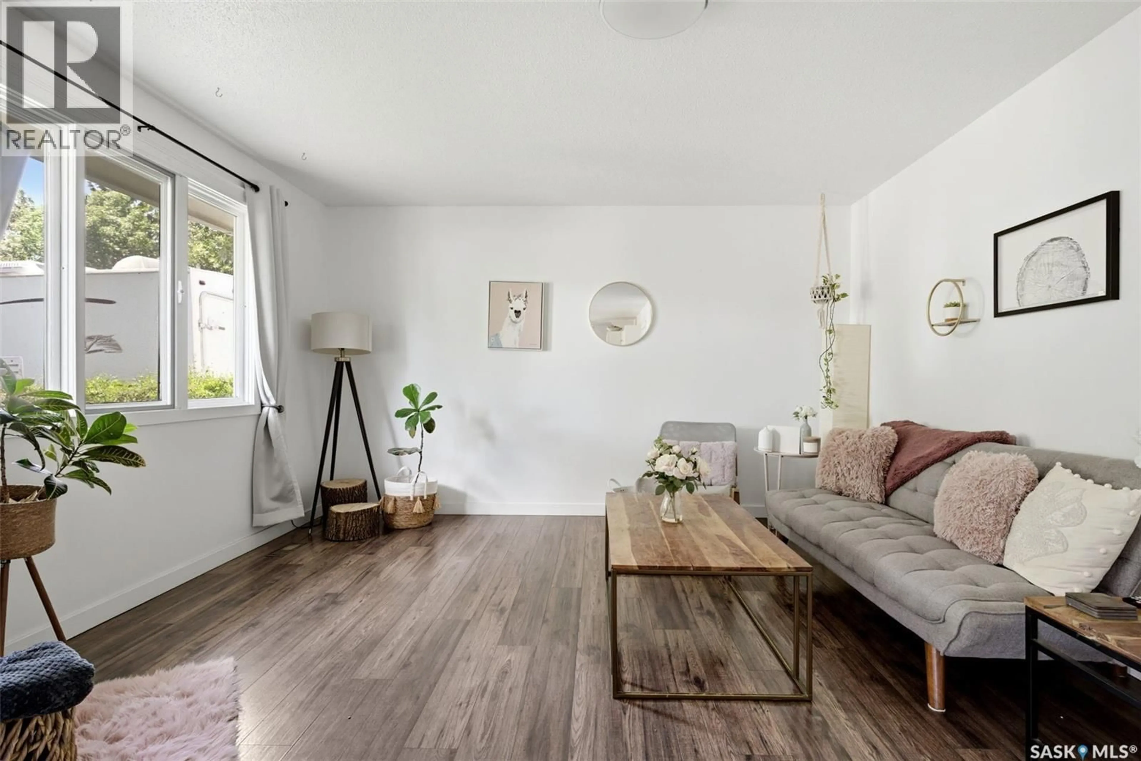 Living room with furniture, wood/laminate floor for 5608 2ND AVENUE, Regina Saskatchewan S4R5M5