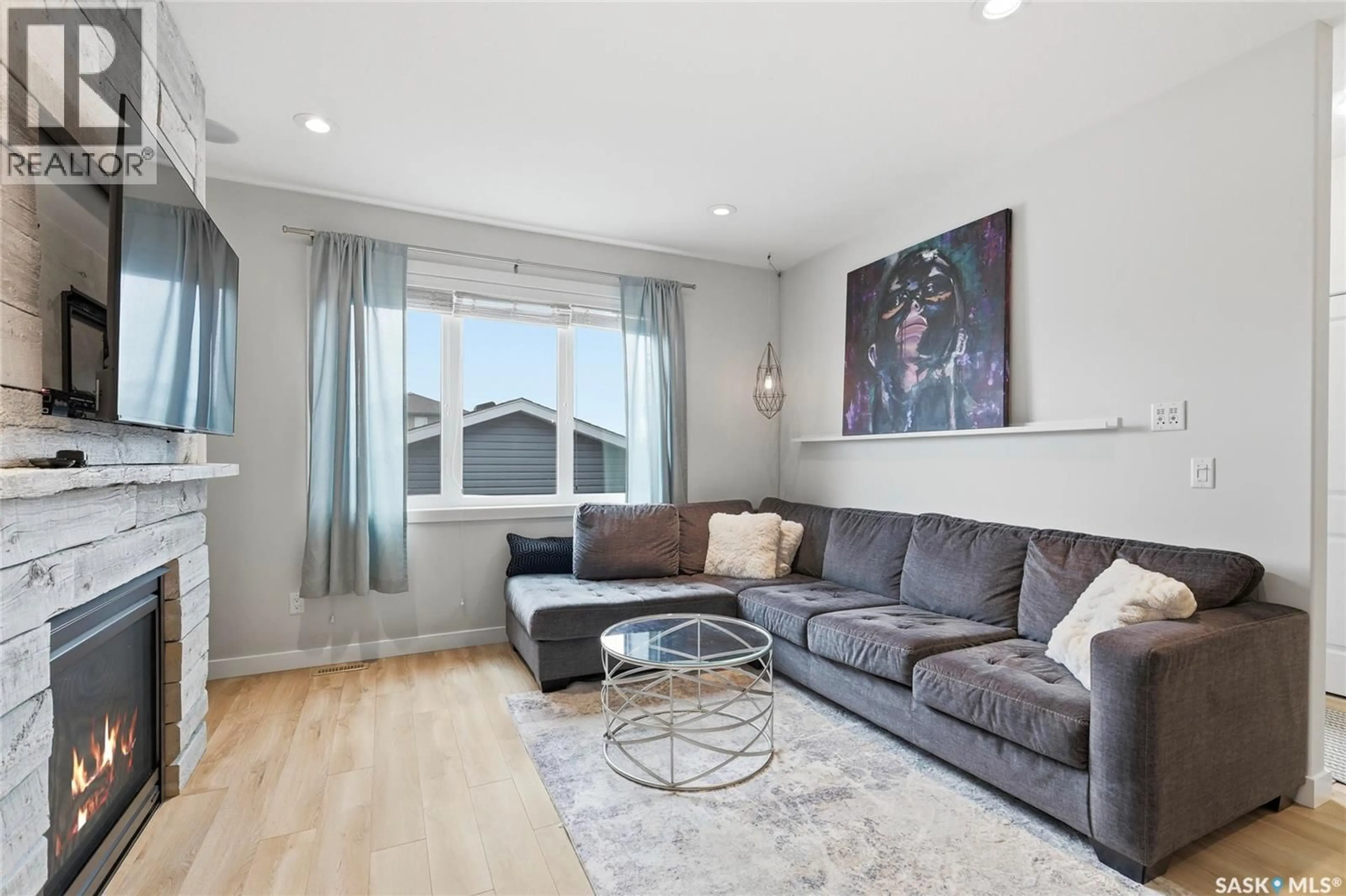 Living room with furniture, wood/laminate floor for 1105 JURASIN STREET, Regina Saskatchewan S4X0K1