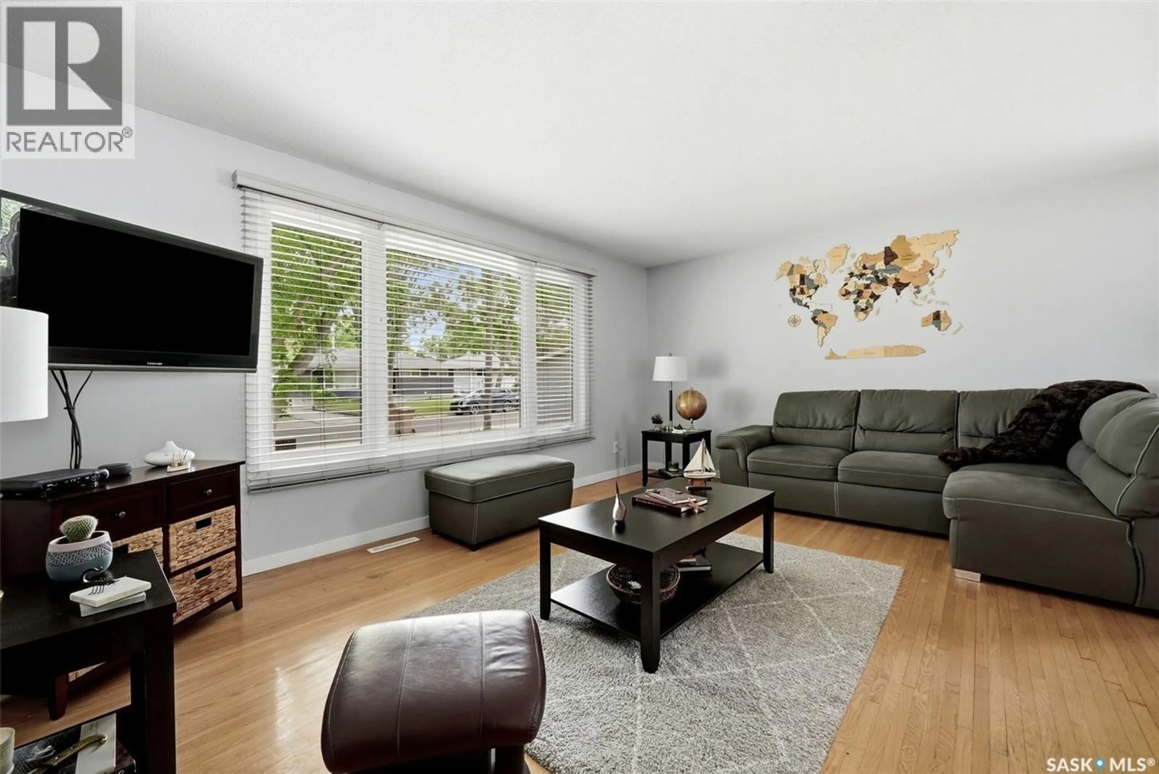 Living room with furniture, wood/laminate floor for 129 MCKEE CRESCENT, Regina Saskatchewan S4S5N7