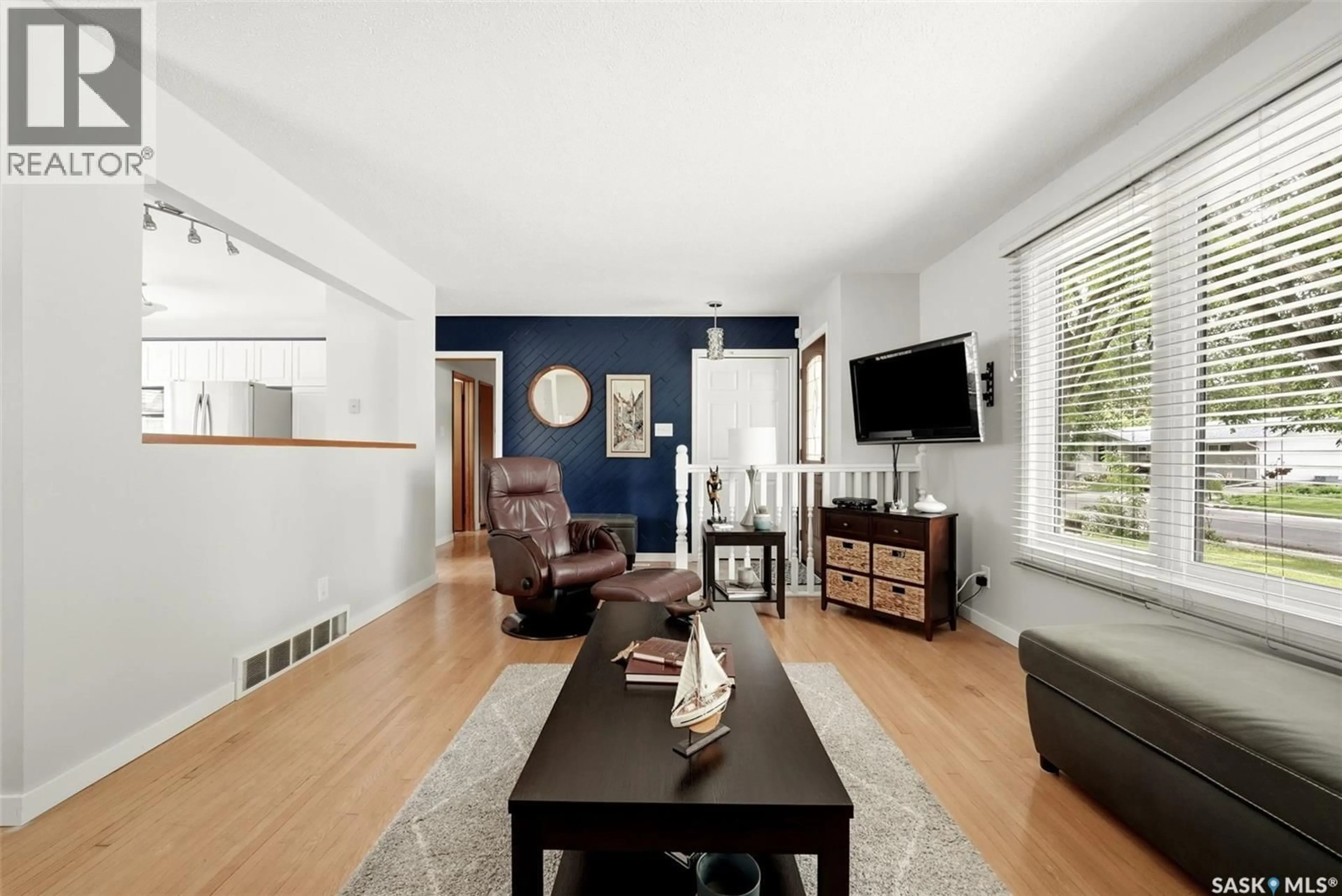 Living room with furniture, wood/laminate floor for 129 MCKEE CRESCENT, Regina Saskatchewan S4S5N7