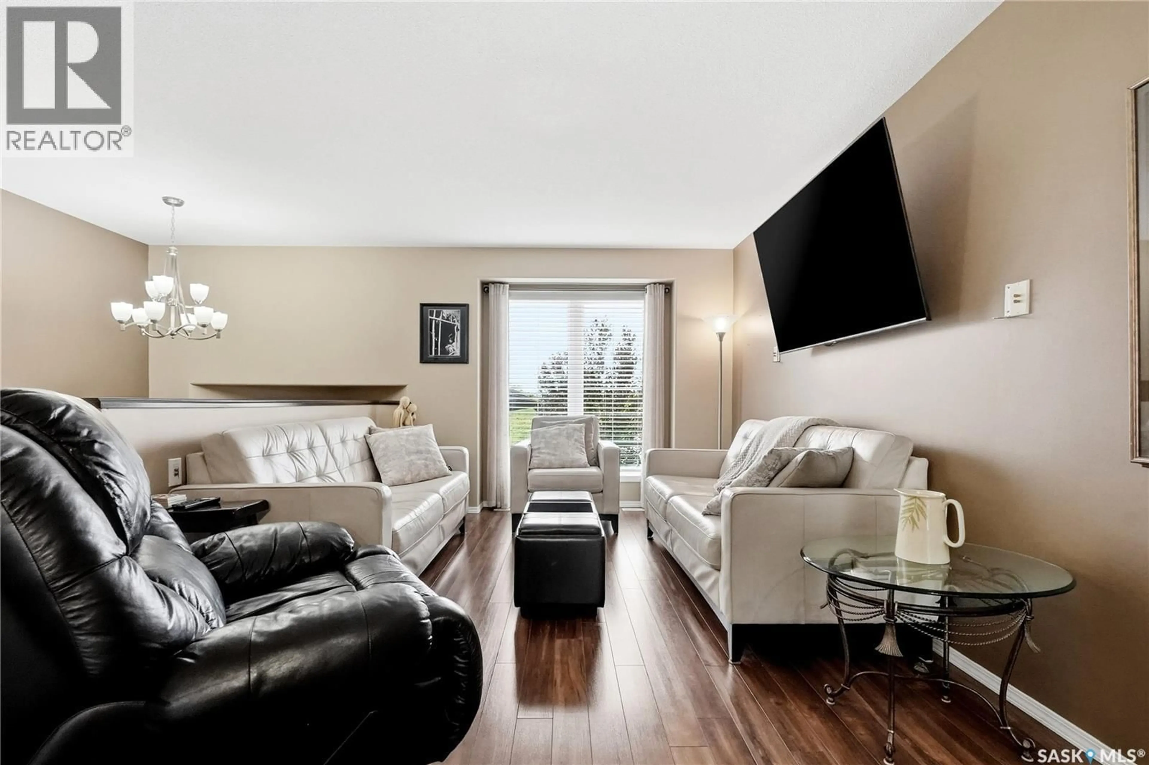 Living room with furniture, wood/laminate floor for 714 LYND CRESCENT, Saskatoon Saskatchewan S7T0C6