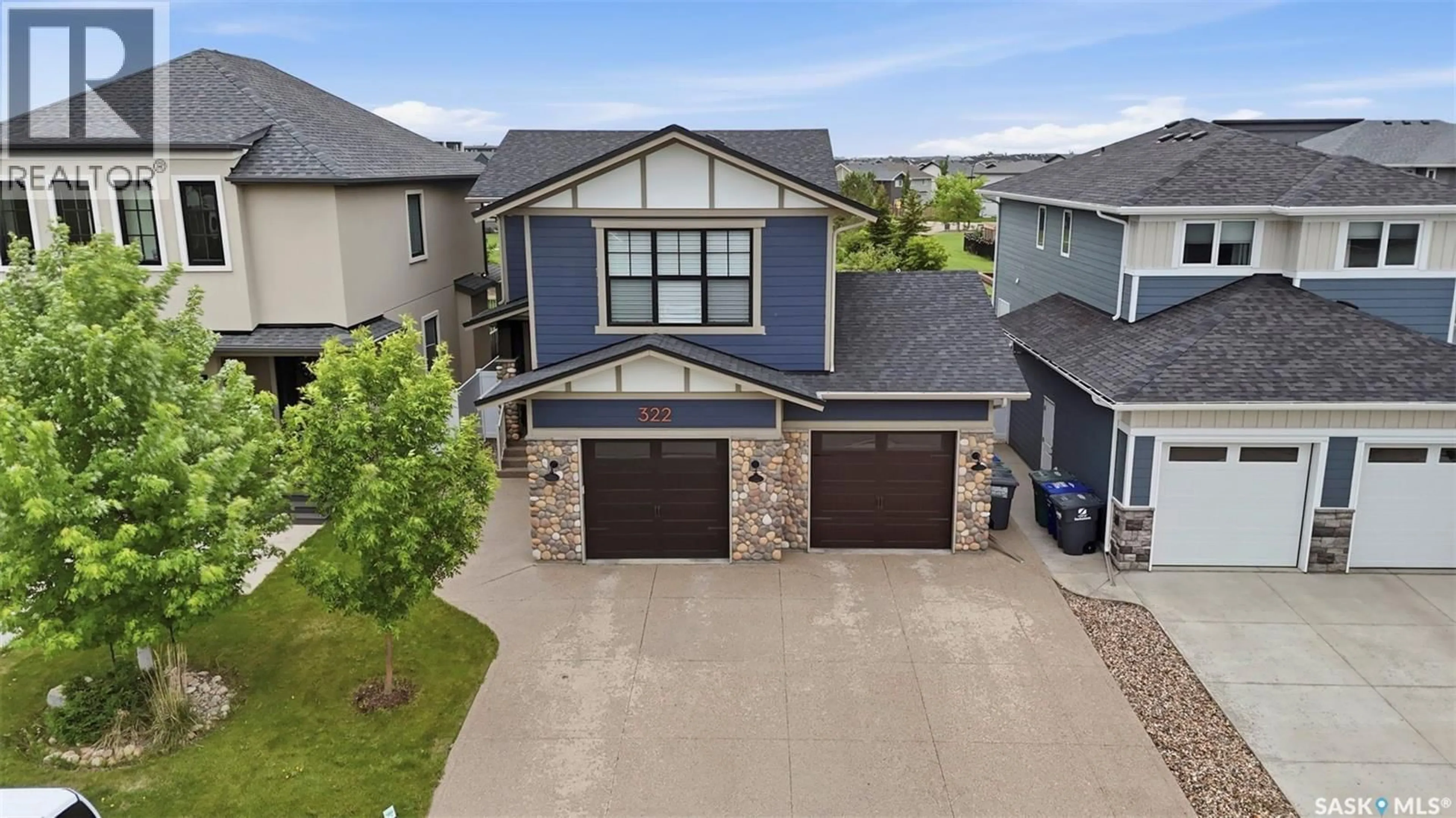 A pic from outside/outdoor area/front of a property/back of a property/a pic from drone, street for 322 DAGNONE CRESCENT, Saskatoon Saskatchewan S7V0P7