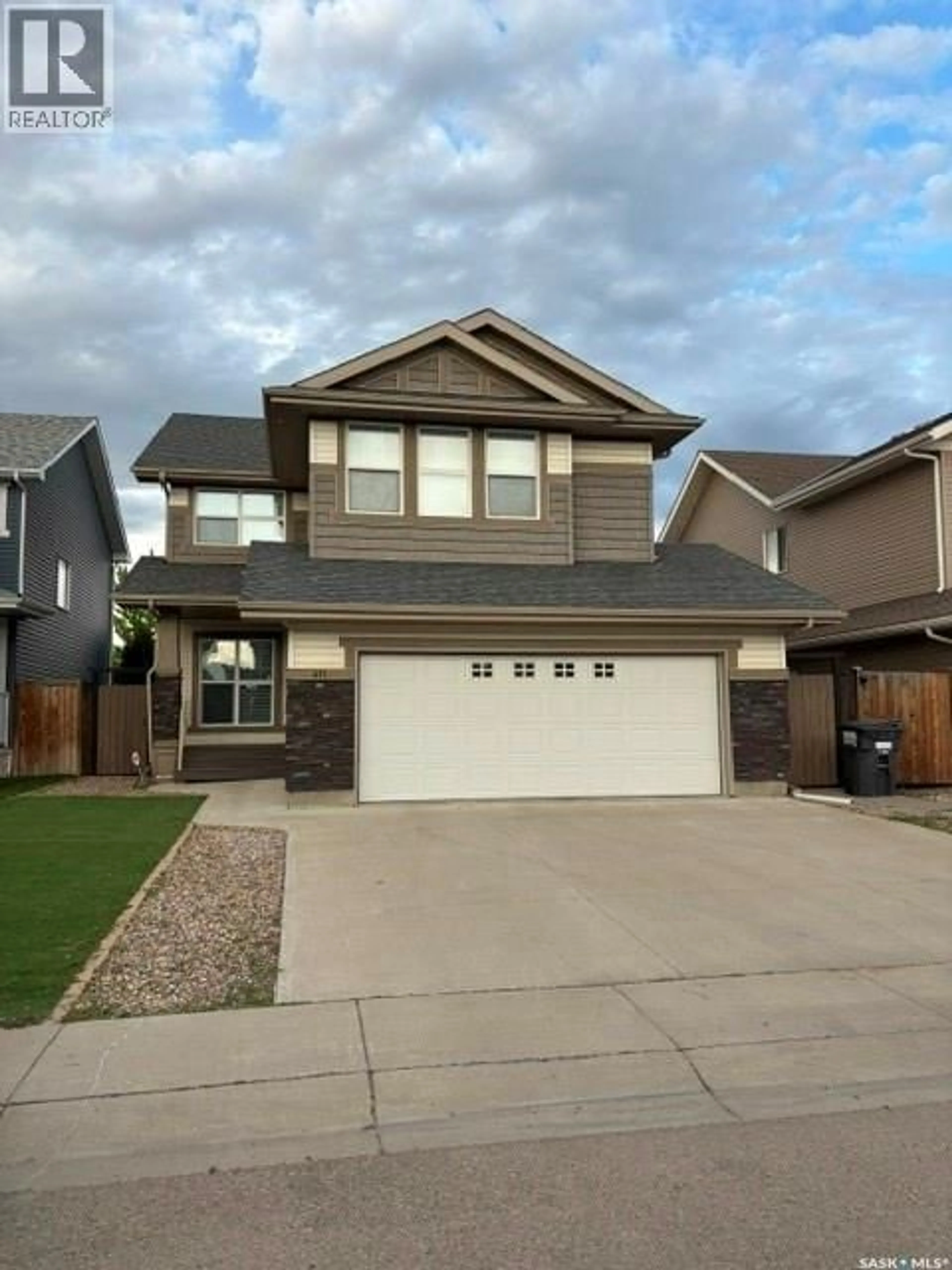 Home with vinyl exterior material, street for 411 FLYNN LANE, Saskatoon Saskatchewan S7V0L1