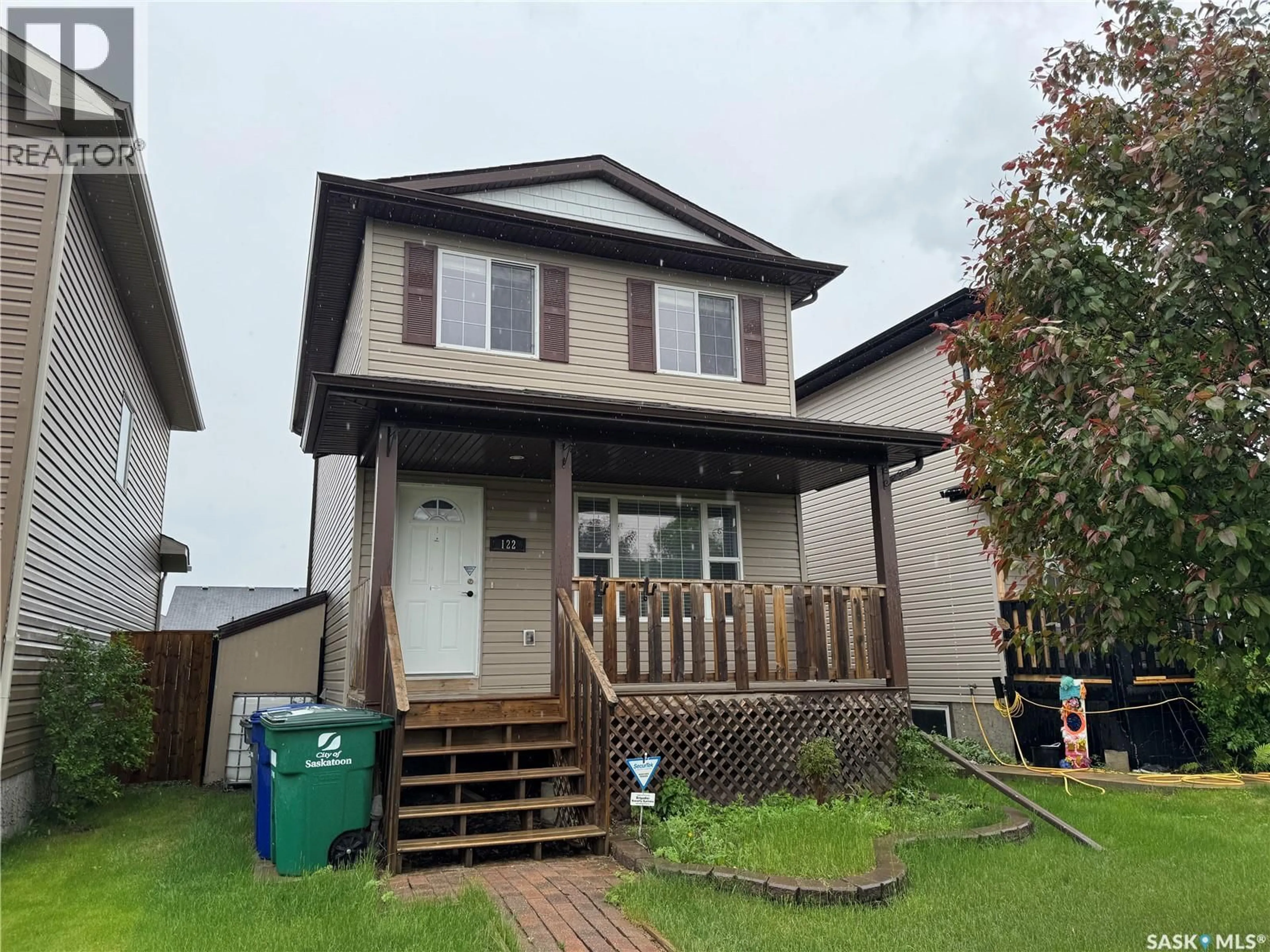 Home with vinyl exterior material, street for 122 KEEDWELL STREET, Saskatoon Saskatchewan S7W1B4