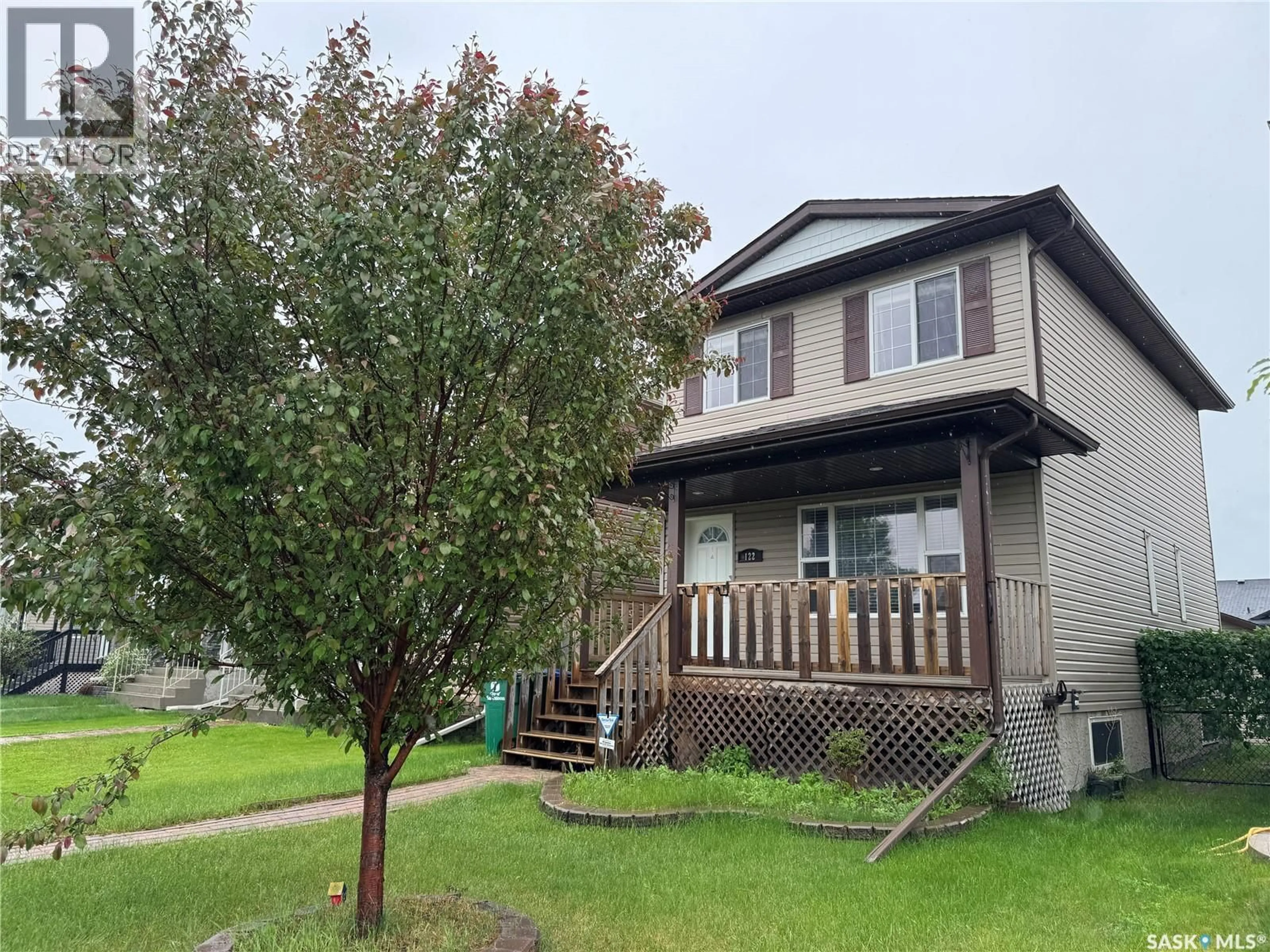 Home with vinyl exterior material, street for 122 KEEDWELL STREET, Saskatoon Saskatchewan S7W1B4