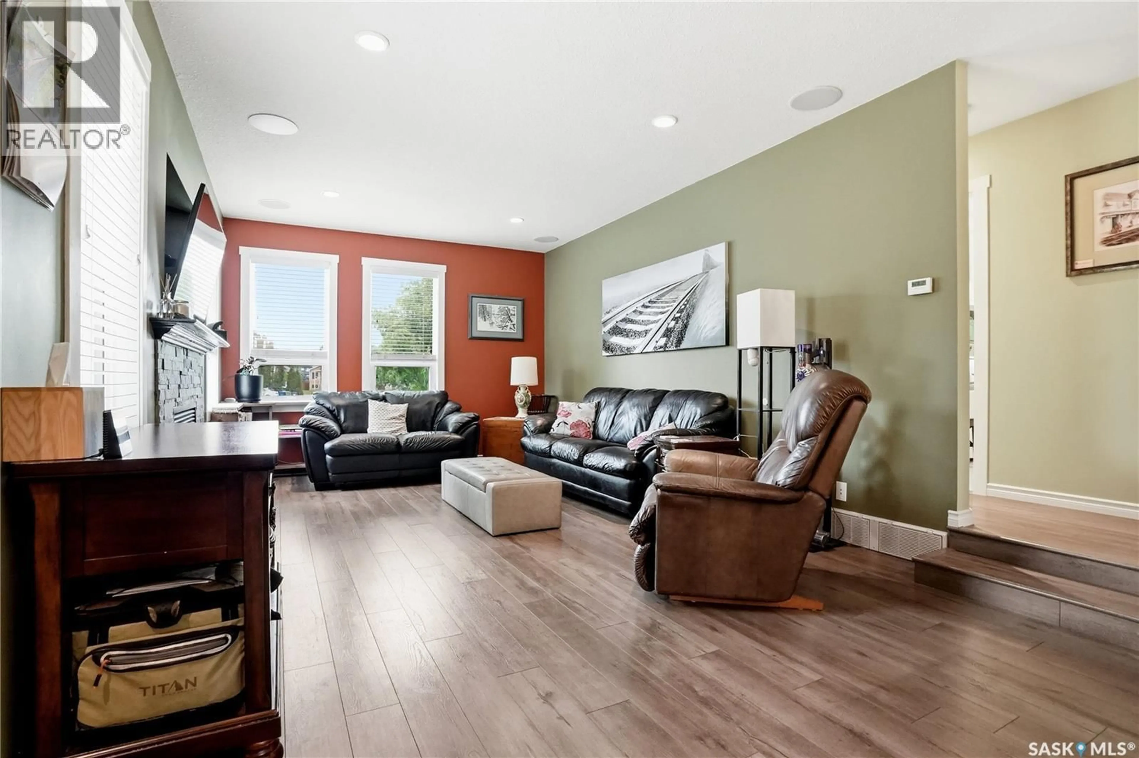 Living room with furniture, wood/laminate floor for 23 BLACKLEY PLACE, Saskatoon Saskatchewan S7M5B1